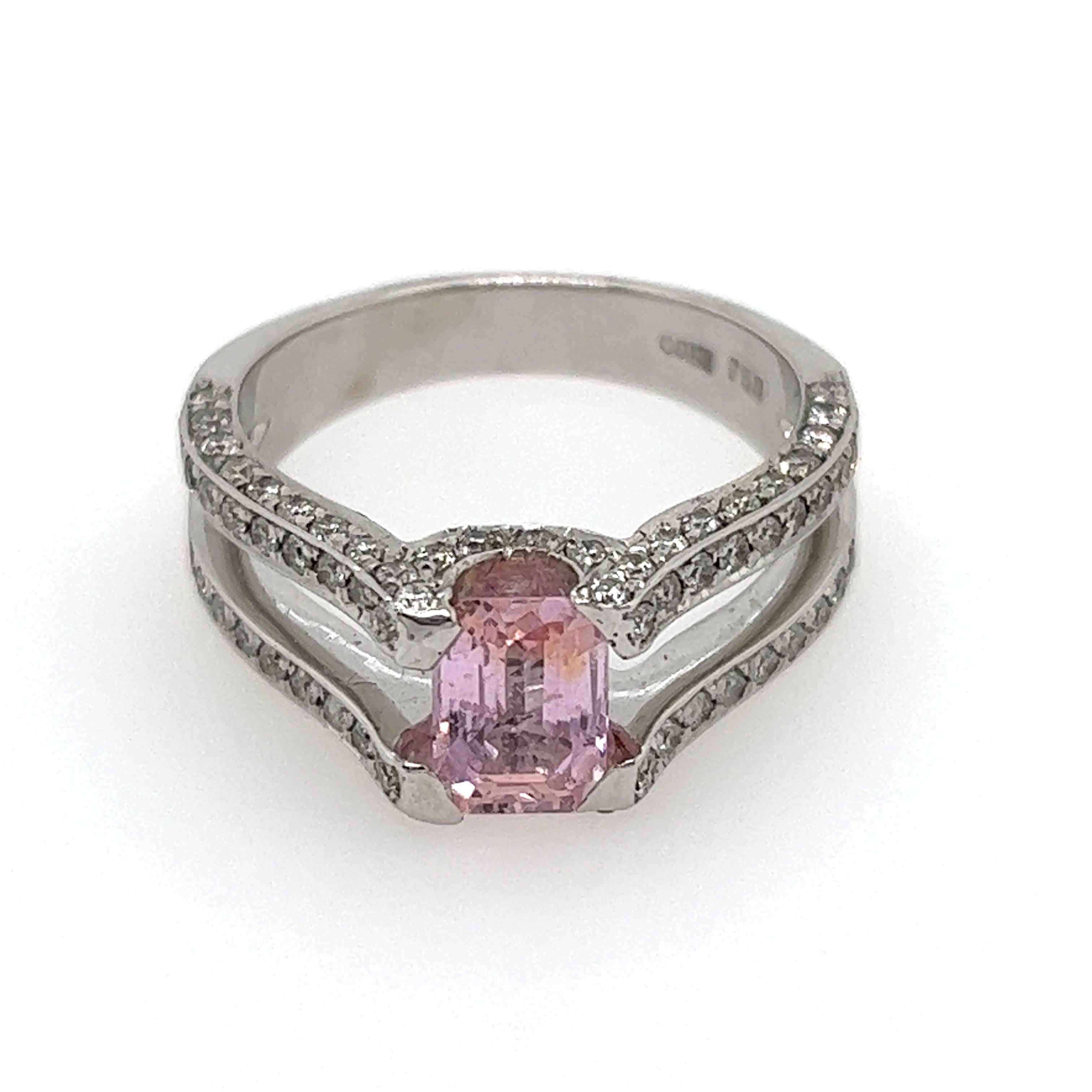 This ring features a dainty 1.01 carat Natural Pink Sapphire at its centre. This baby pink emerald cut stone is set in a claw setting on a flawless 18K White Gold band, its gentle hues brought out by the band it sits on. 

Also on this band, on