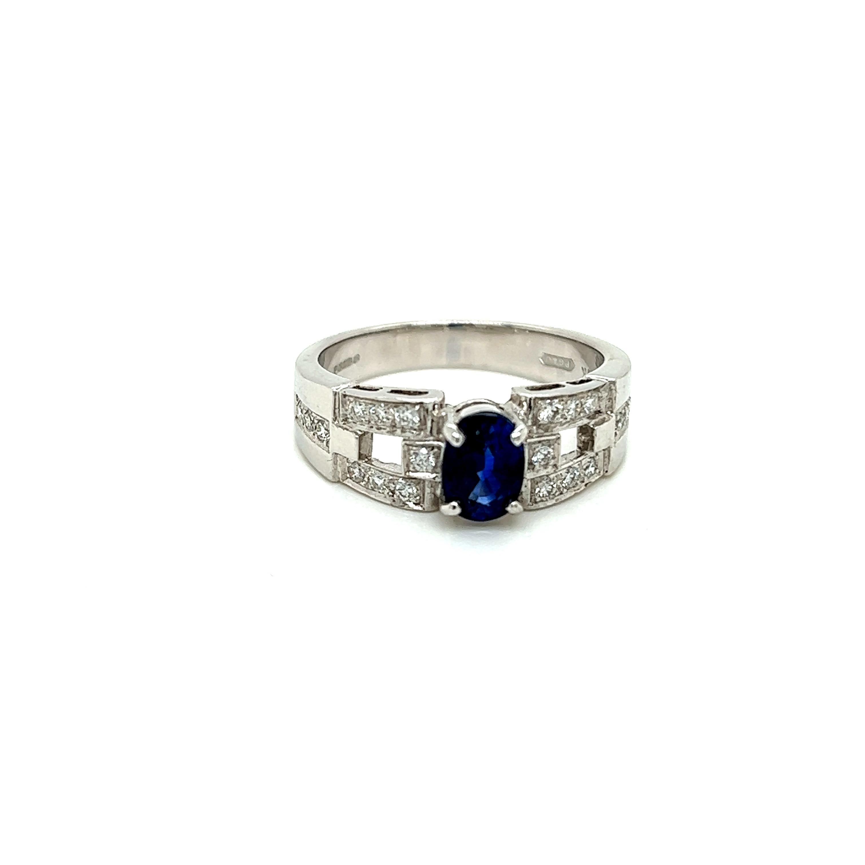 This stunning ring features an alluring Blue Sapphire held in a claw setting on a unique 18K White Gold band. Encrusted on the band are iridescent Round Brilliant Diamonds arranged in a contemporary chequered pattern.

The Oval cut Blue Sapphire