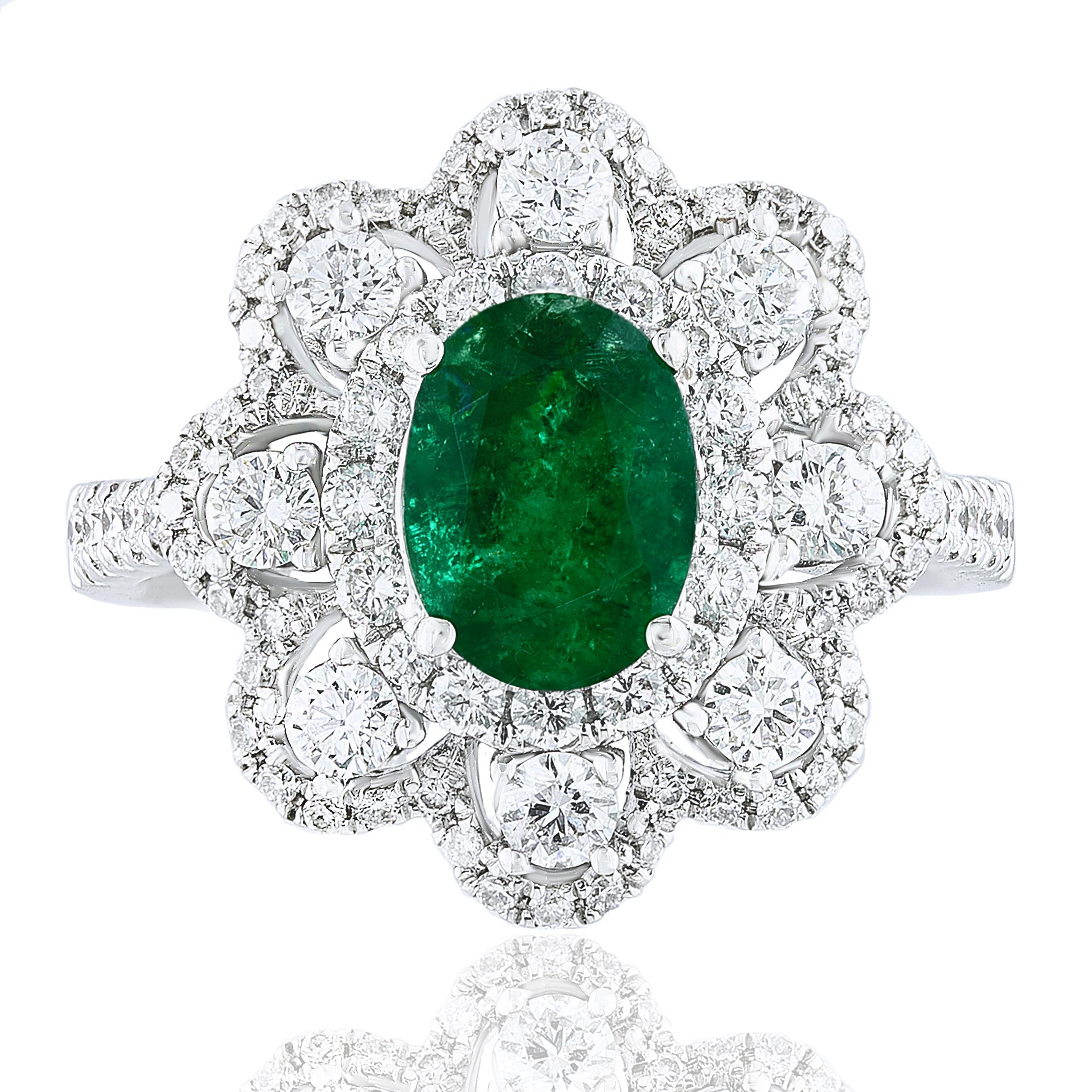 A stylish cocktail ring showcasing a 1.01-carat color-rich emerald, surrounded by rows of round brilliant diamonds in a flower design. 54 Diamonds weigh 1.10 carats in total. Made in 18k white gold.

Size 6.5 US (Sizable). One of a Kind piece.
All