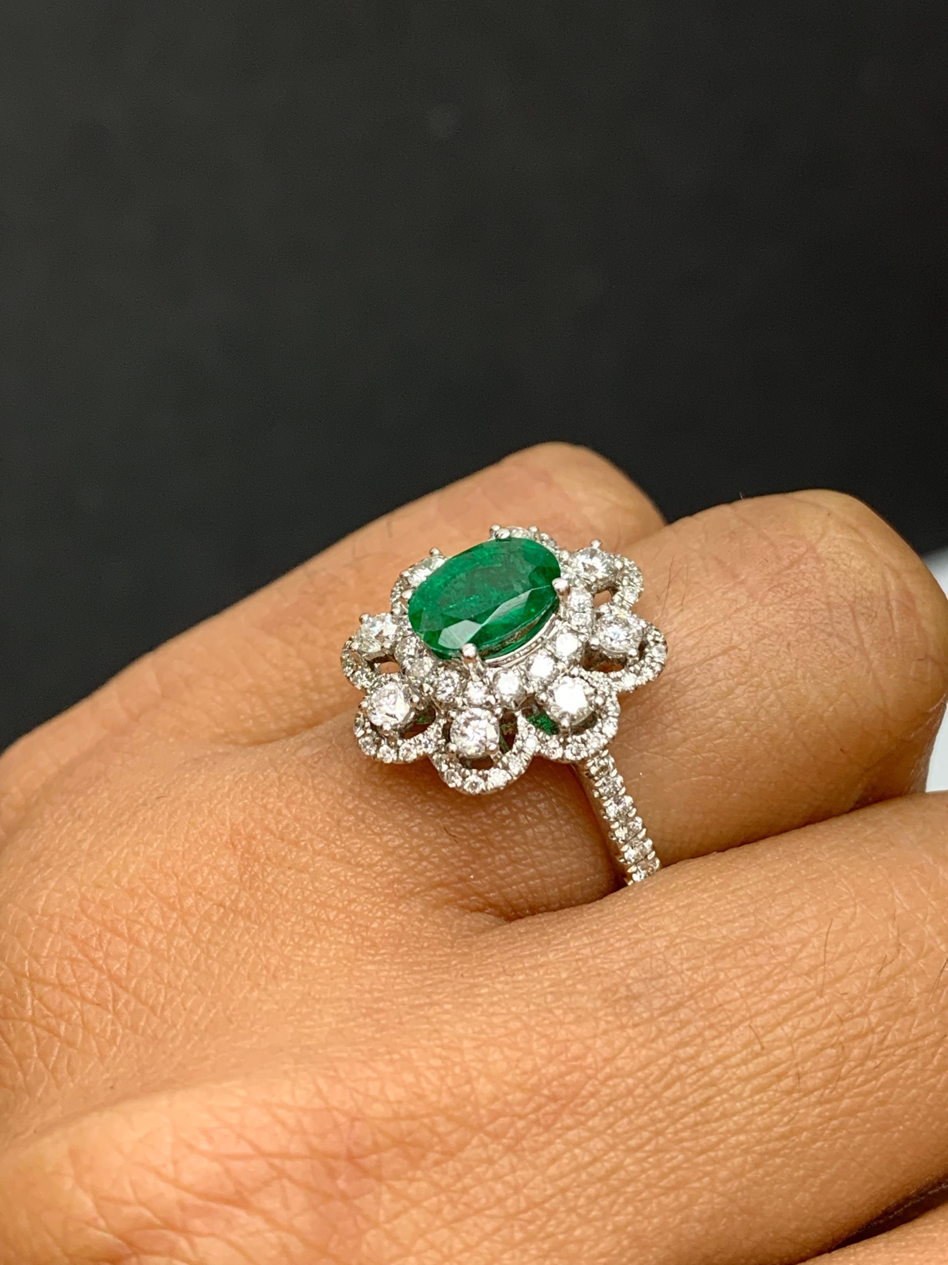 Women's 1.01 Carat Oval Emerald and Diamond Cocktail Flower Ring in 18K White Gold For Sale