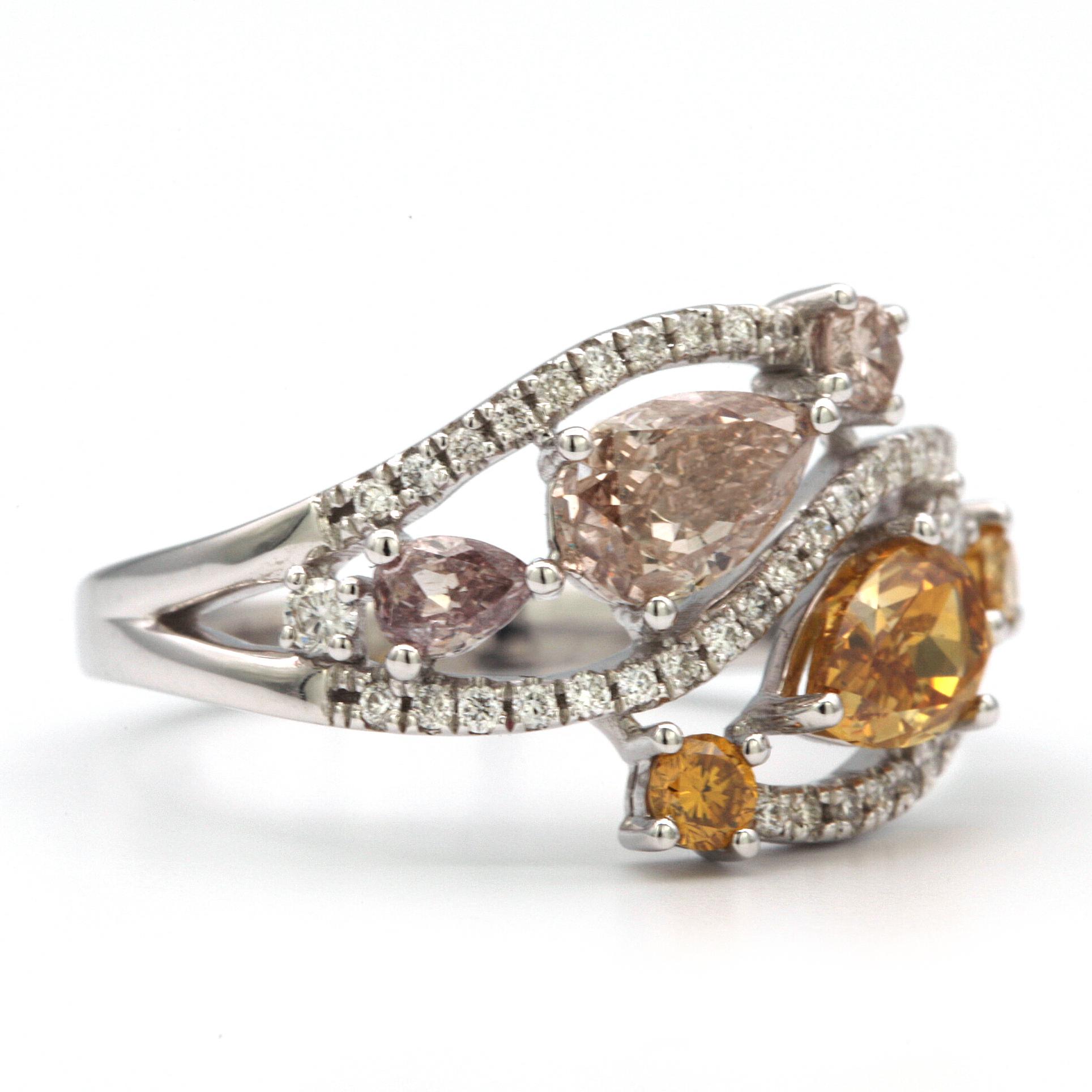 This beautiful ring features two Pear shaped stones, one being approx. 0.51ct Fancy Deep Orangy Yellow SI1/SI2, the other being 0.50ct  Light Brown  I1.
Two smaller Pear shaped stones in the ring are approx. 0.17ct , one being Fancy Light Purplish,