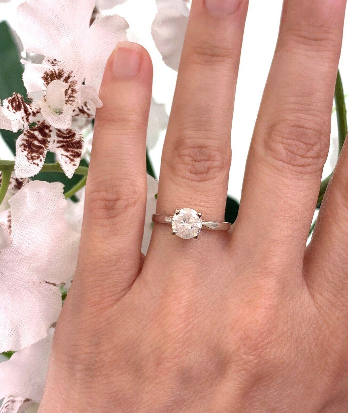 Round Brilliant Diamond Ring
Style: Solitaire Engagement Ring
Metal: 14K White Gold
Size / Measurements:  6.5, sizable
TCW: 1.01 Carats
Diamond:  Round Brilliant Cut
Color & Clarity:  G Color, I2 Clarity (Salt & Pepper)
Hallmark: 14K, 1.01
Includes: