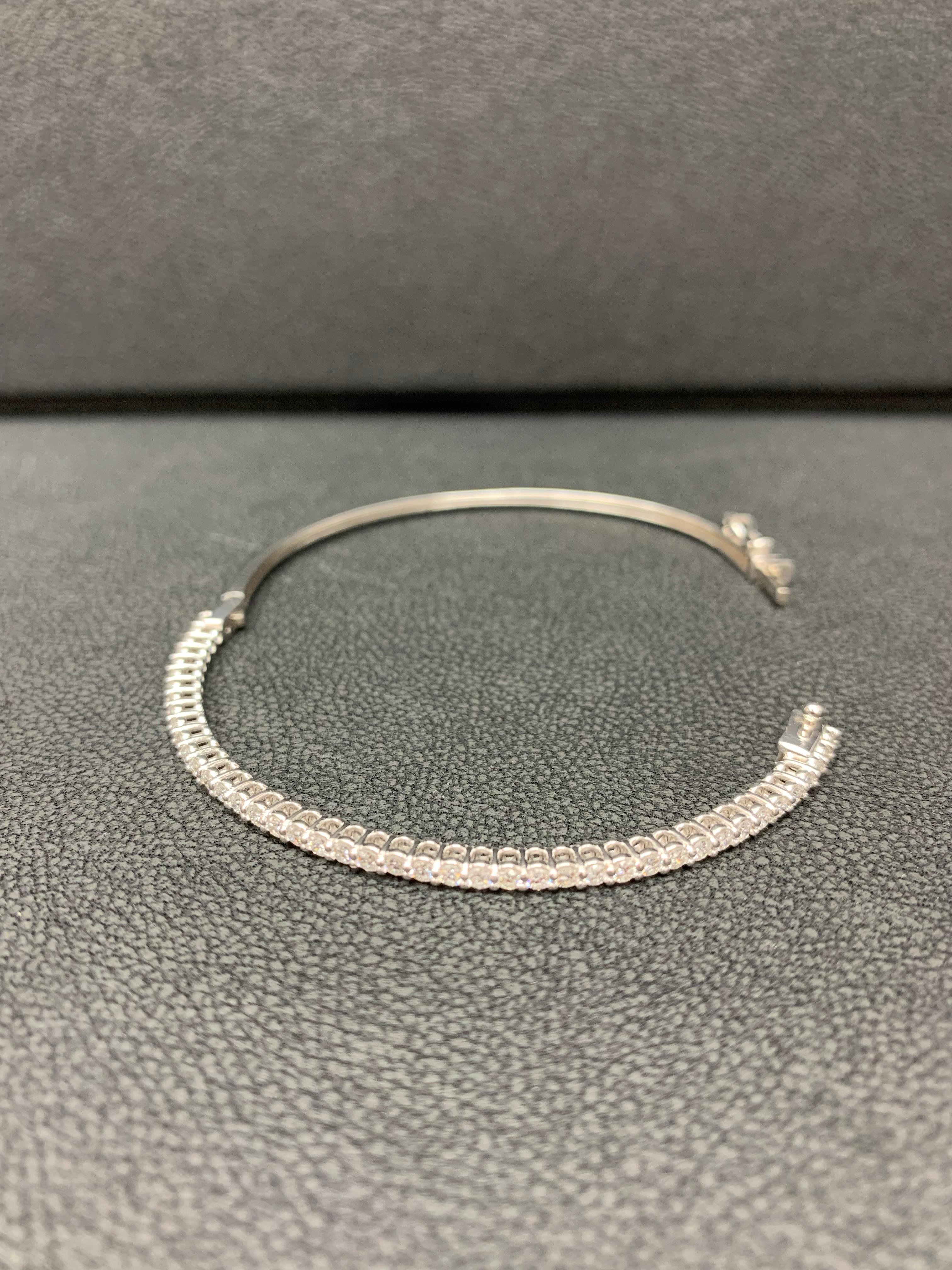 A simple but elegant bangle bracelet set with 43 round-cut diamonds weighing 1.01 carats total. Has a clasp to slip and wear the bangle securely. Made in 14k White Gold.

Style available in different price ranges. Prices are based on your selection