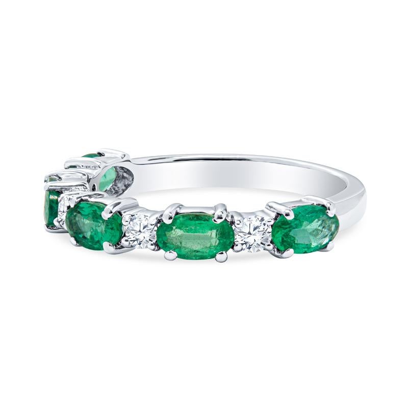 This band features 1.01 carat total weight in oval shaped emeralds alternating with 0.20 carat total weight in round diamonds set in 14 karat white gold. Wear alone or layer with your other favorite bands. It is a size 6.25 but can be resized upon