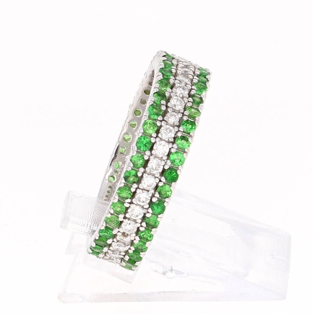 A cute and dainty Tsavorite and Diamond Band that is sure to be a great addition to your jewelry collection.  This band has 2 rows of Tsavorites and 1 row of Diamonds. There are a total of 60 Round Cut Tsavorites that weigh 0.67 carats and 36 Round