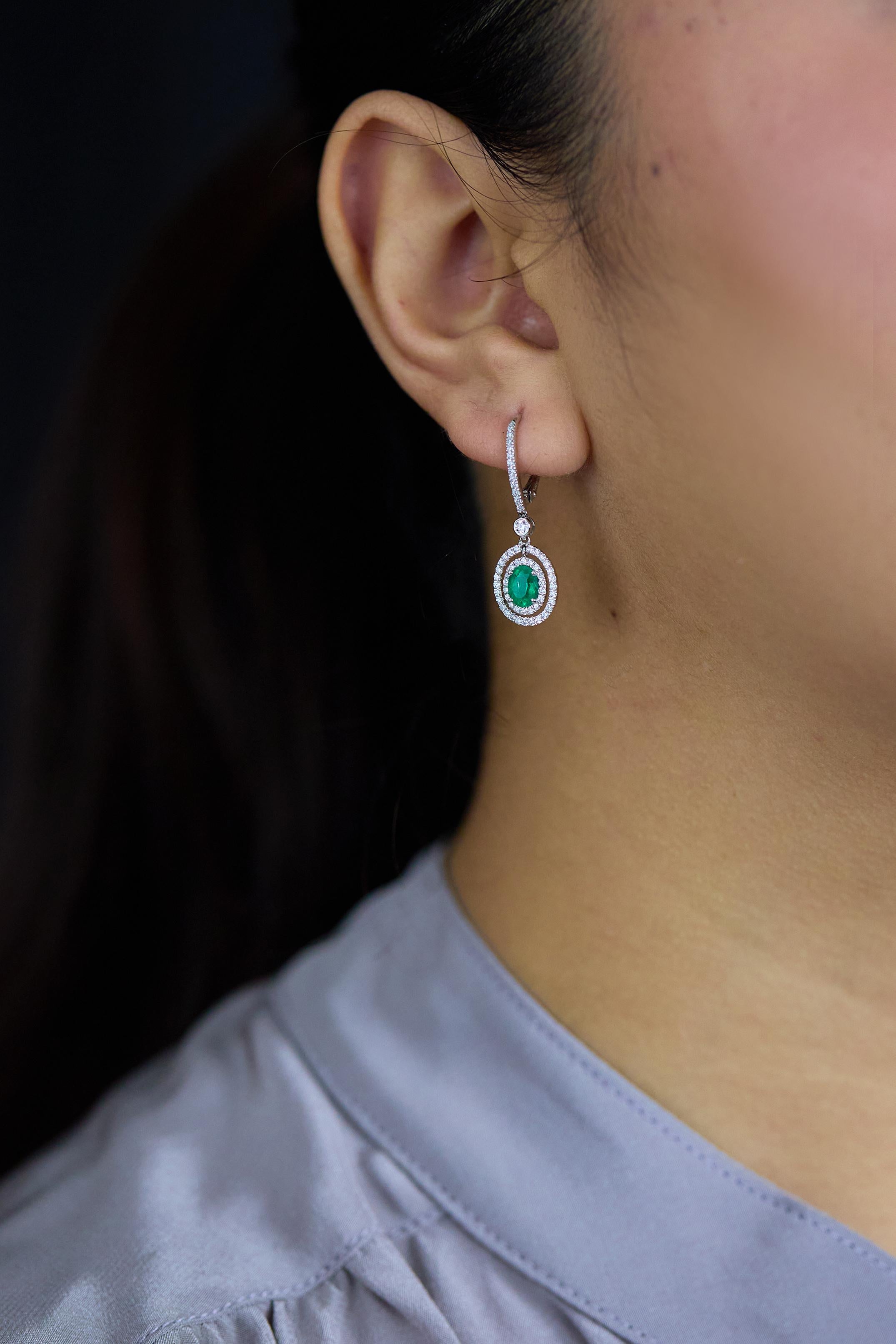 1.01 Carats Total Oval Cut Emerald and Diamond Halo Dangle Earrings In New Condition For Sale In New York, NY