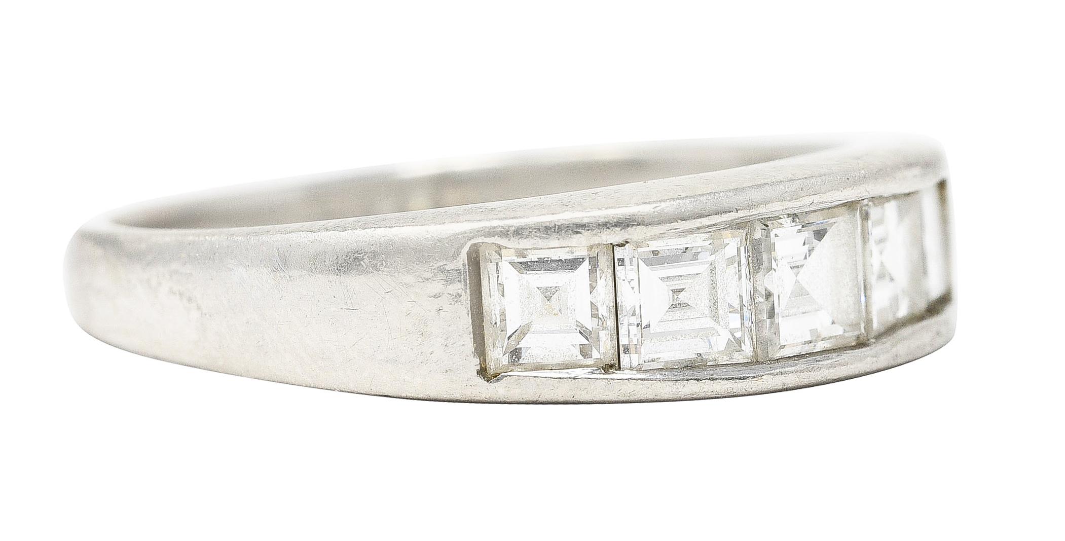 Featuring five square step cut diamonds weighing 1.01 carats total. I color with VS2 clarity - channel set to front. Completed by matte finish. Stamped for platinum. Inscribed with carat weight. Circa: 1990's. Ring size: 7 and sizable. Measures: