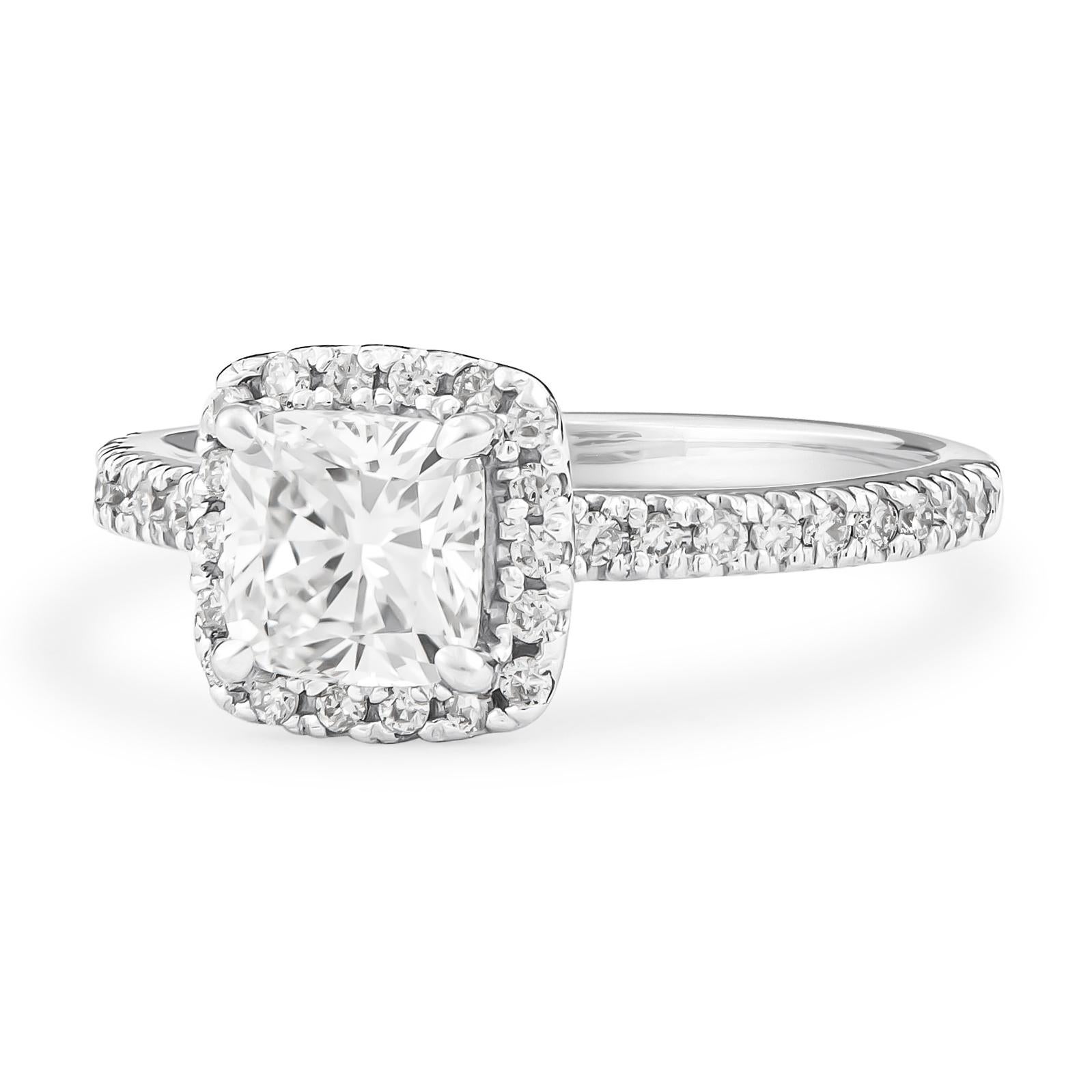 Dazzling 1.01 carat cushion cut center diamond with 0.40 carats total of round brilliant cut diamonds perfectly set in halo form. This engagement ring has been expertly crafted here in our store in platinum setting and is also accompanied by its own
