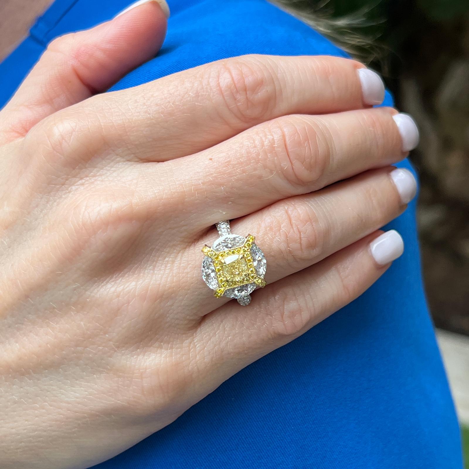 Atemberaubender Verlobungsring mit gelben und weißen Diamanten aus 18 Karat Gelb- und Weißgold. Der Ring enthält einen gelben Diamanten im Kissenschliff von 1,01, der vom GIA mit NFY/SI2 bewertet wurde. Die 4 weißen Marquise-Diamanten haben ein
