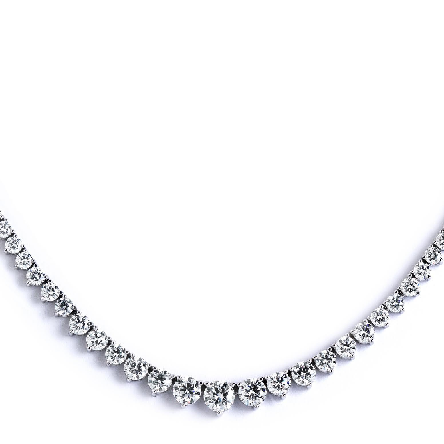 This exquisite graduated riviera necklace set in handmade 18k white gold featuring perfectly cut ideal round brilliant diamonds. the super white diamonds are in E-F color and VVS to VS clarity with a total carat weight of 10.11 This precious