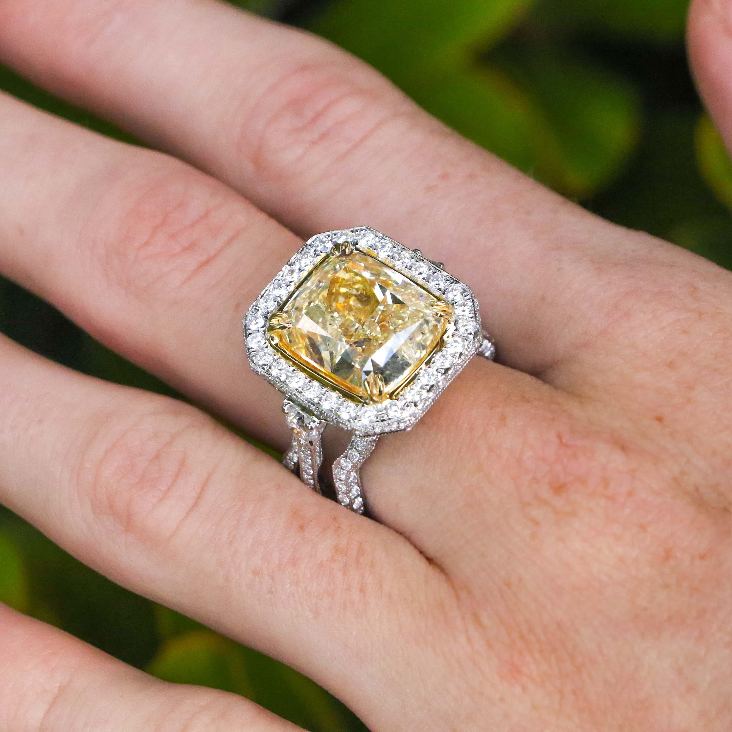 This ring boldly displays a stunning 10.12-carat canary diamond at its center crowning an intricate diamond set band. The center diamond is surrounded by F color diamonds that lead into this ring's beautiful waving band.

• 10.12 Carat Canary