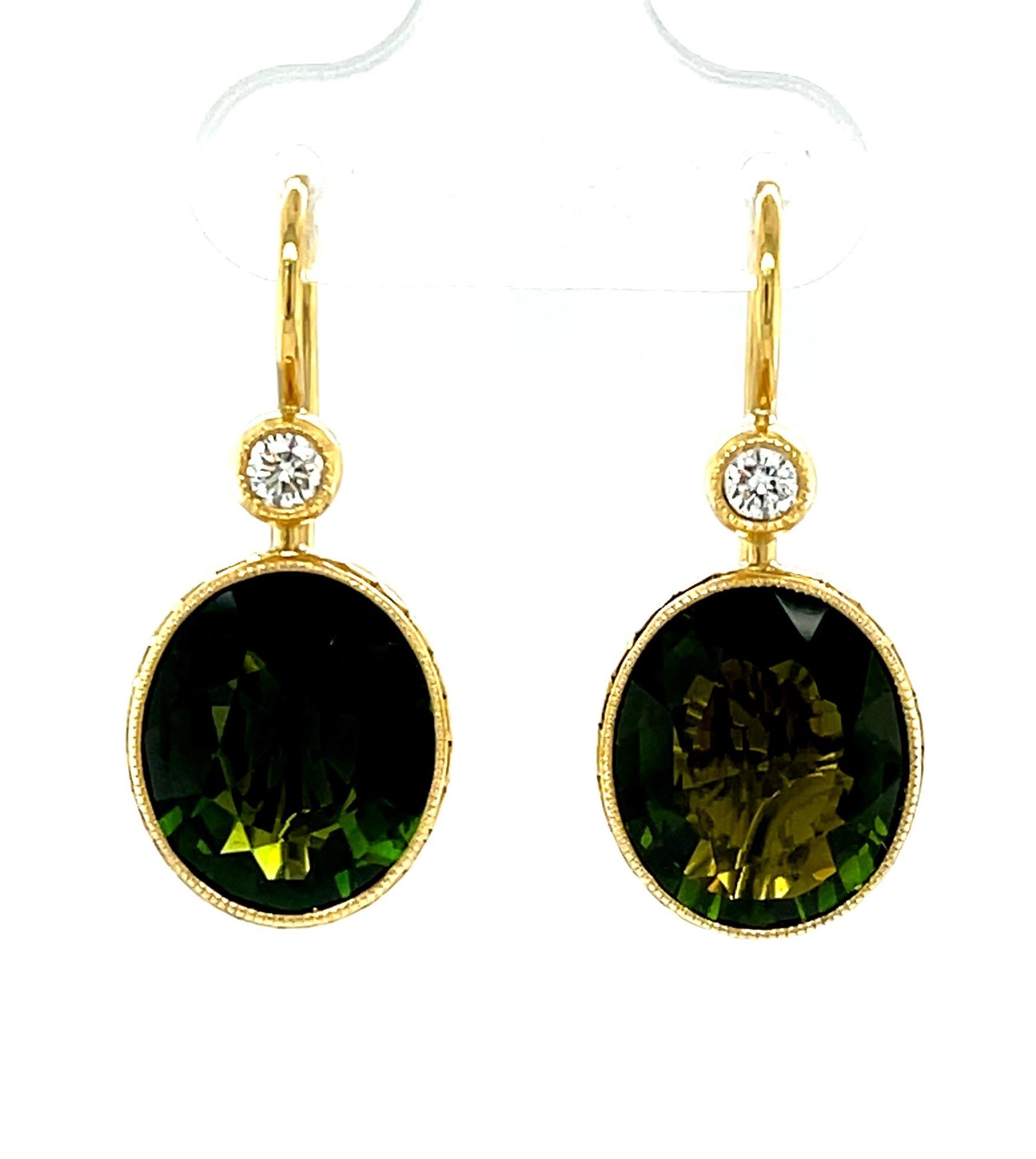 These pretty dangling earrings will add a great finishing touch to any outfit!  Large, richly colored,  olive green tourmaline ovals are bezel set in 18k yellow gold and dangle from bezel set round sparkling diamonds for a look that transitions