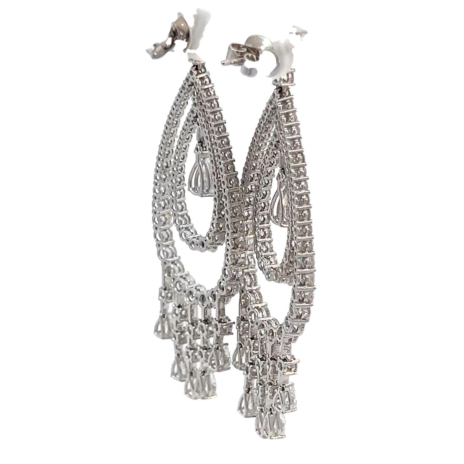 18 karat white gold 10.14 carat diamond dangle chandelier earrings. These dazzling pair of statement chandelier earrings exhibit beautiful movement and sparkle.  
With a total carat weight of 10.14 carats, these earrings are designed with an array