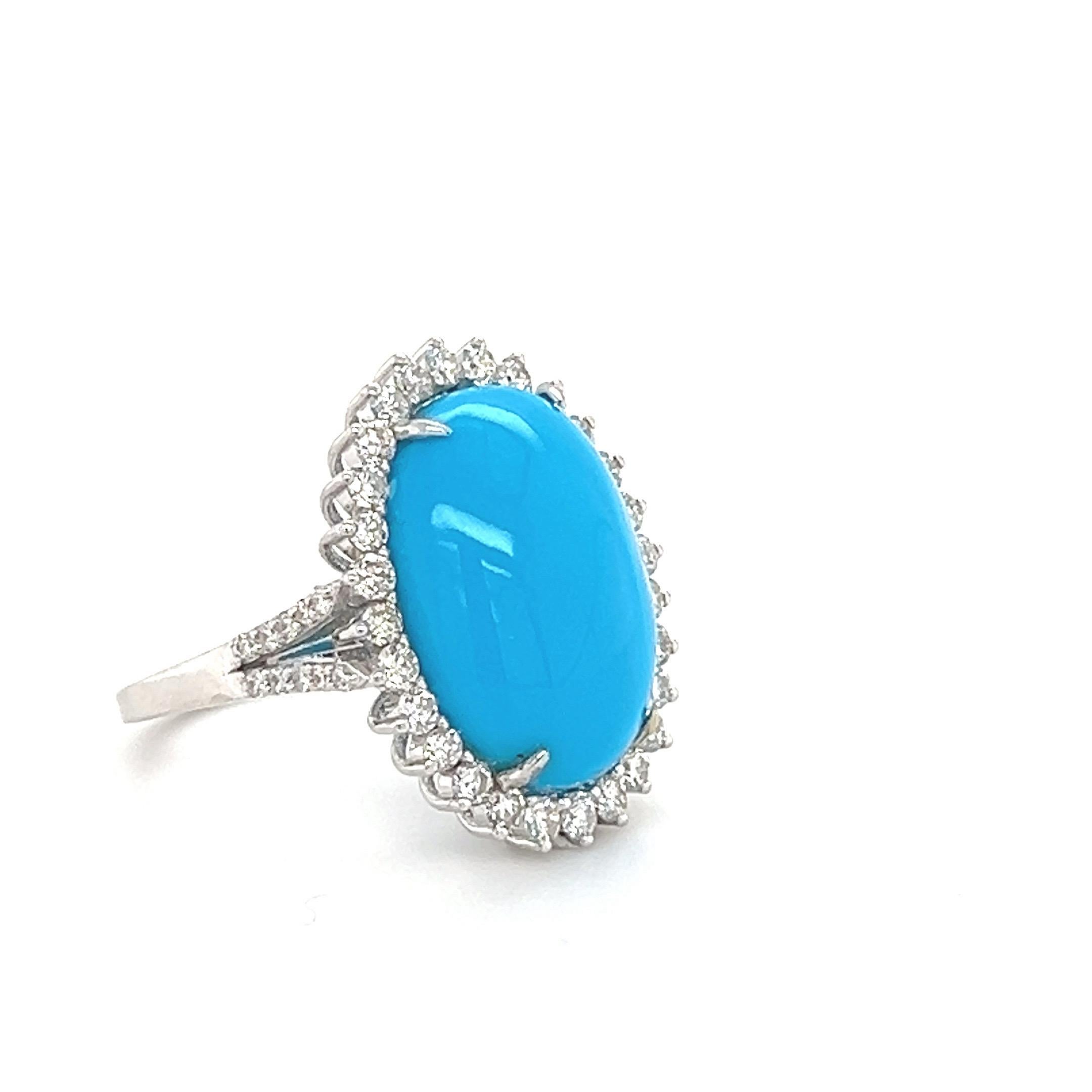 Glamorous Turquoise diamond cocktail ring. Natural oval cabochon 10.14 carats blue turquoise mounted in high profile, accented with halo design round brilliant cut diamonds. Handcrafted design set in 18 karats white gold. 

Turquoise: 10.14 karat,