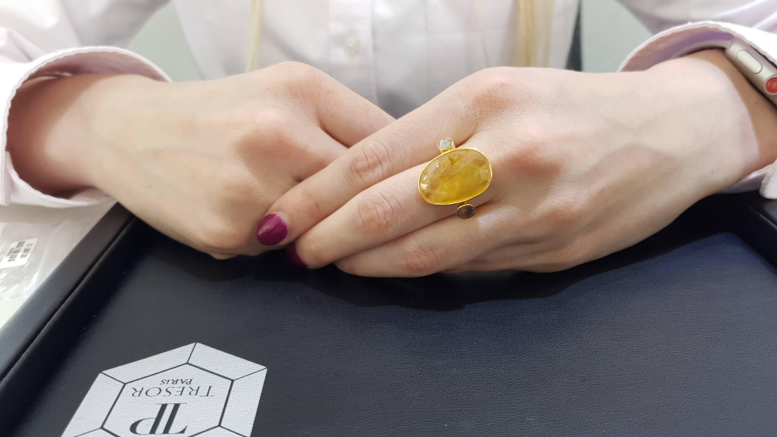 This Gorgeous 10.00 Carat Yellow Sapphire ring features 0.15 Carat in two Diamond slices on each side set in 18 Karat Yellow Gold. This unique yellow sapphire and Diamond 3 stone Rose Cut ring is perfect for any occasion night or day. Each piece is