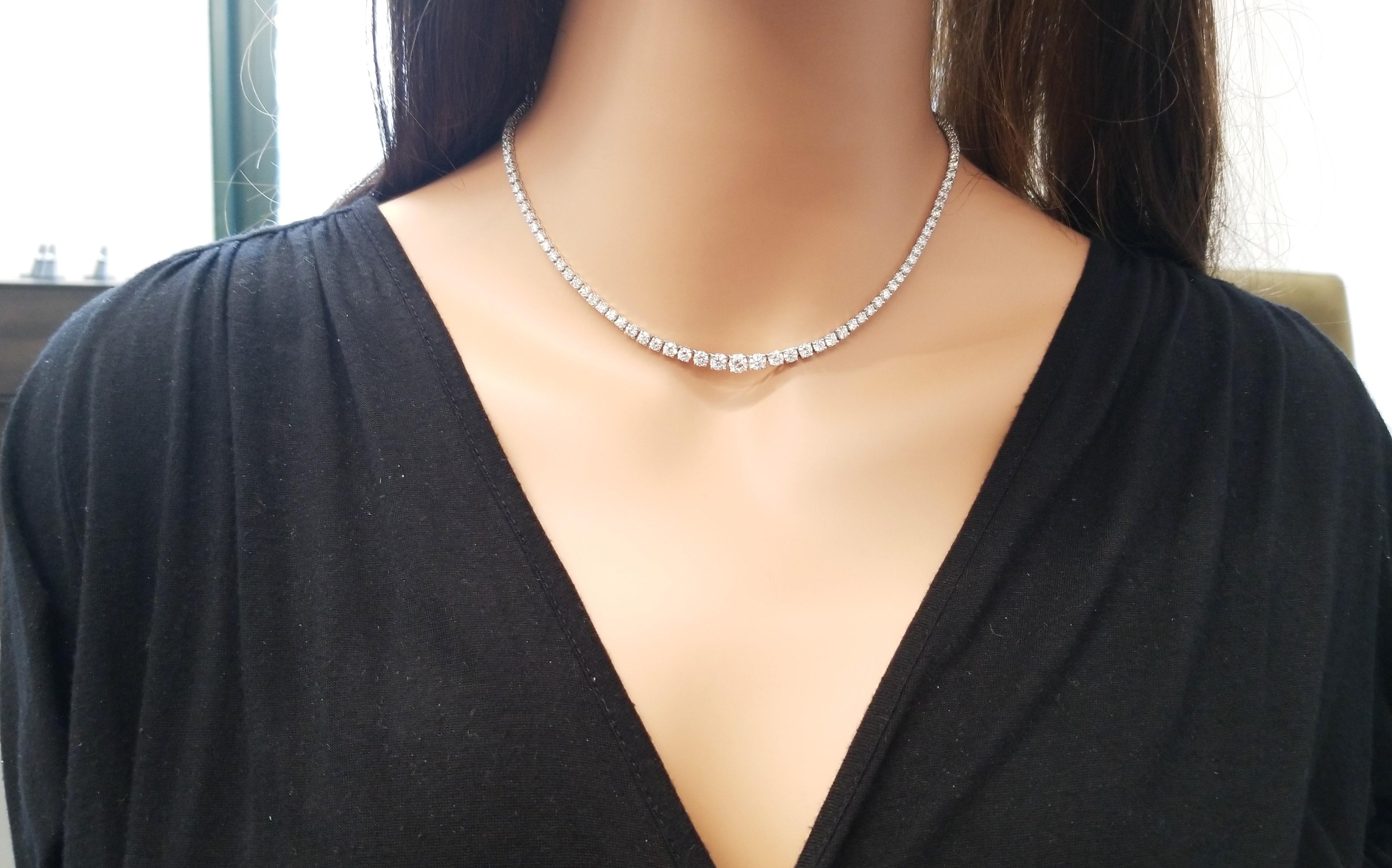 This is a graduated diamond riviera necklace. 125 round brilliant cut diamonds totaling 10.16 carats are precision set in the 4 prong classic setting. The diamonds complete around this outstanding piece in 14k white gold. With your hair up, you have