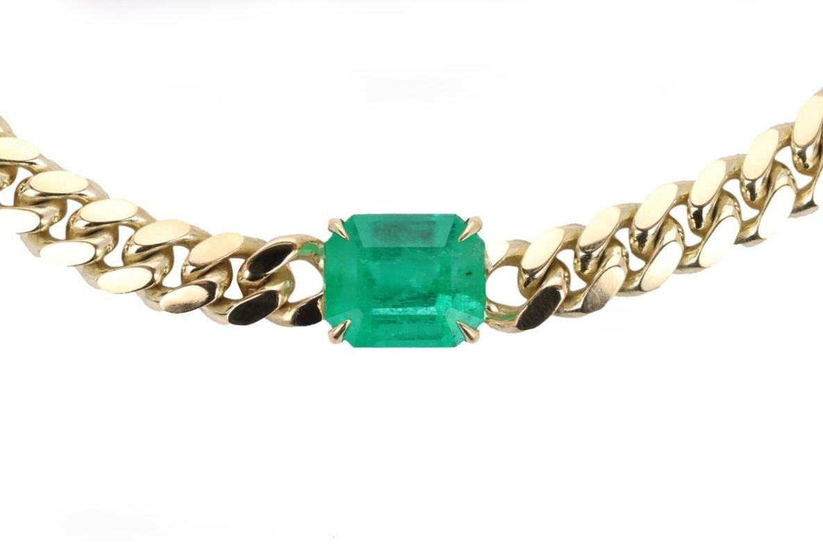 Featured here is a 10.17-carat stunning, East to West emerald choker necklace in 14K yellow gold. Displayed in the center is a natural emerald Colombian emerald accented by a simple prong setting, allowing for the emerald to be shown in full view.