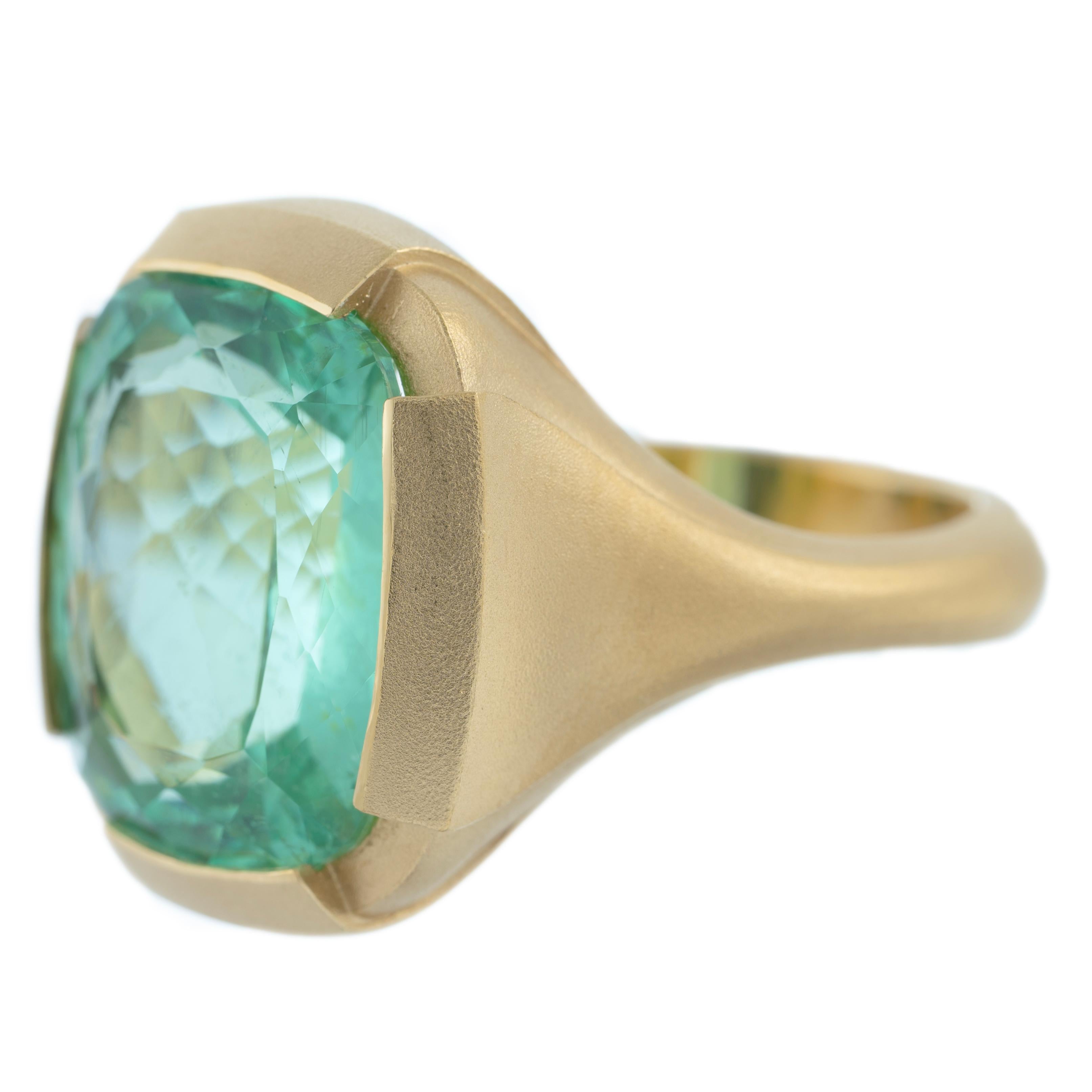 An incredible ring design by jeweler Geoffrey Good featuring a one-of-a-kind Paraiba Tourmaline. The design inspiration is consistent with Geoffrey's minimalist style, yet a design that with further examination consists of layers of depth to
