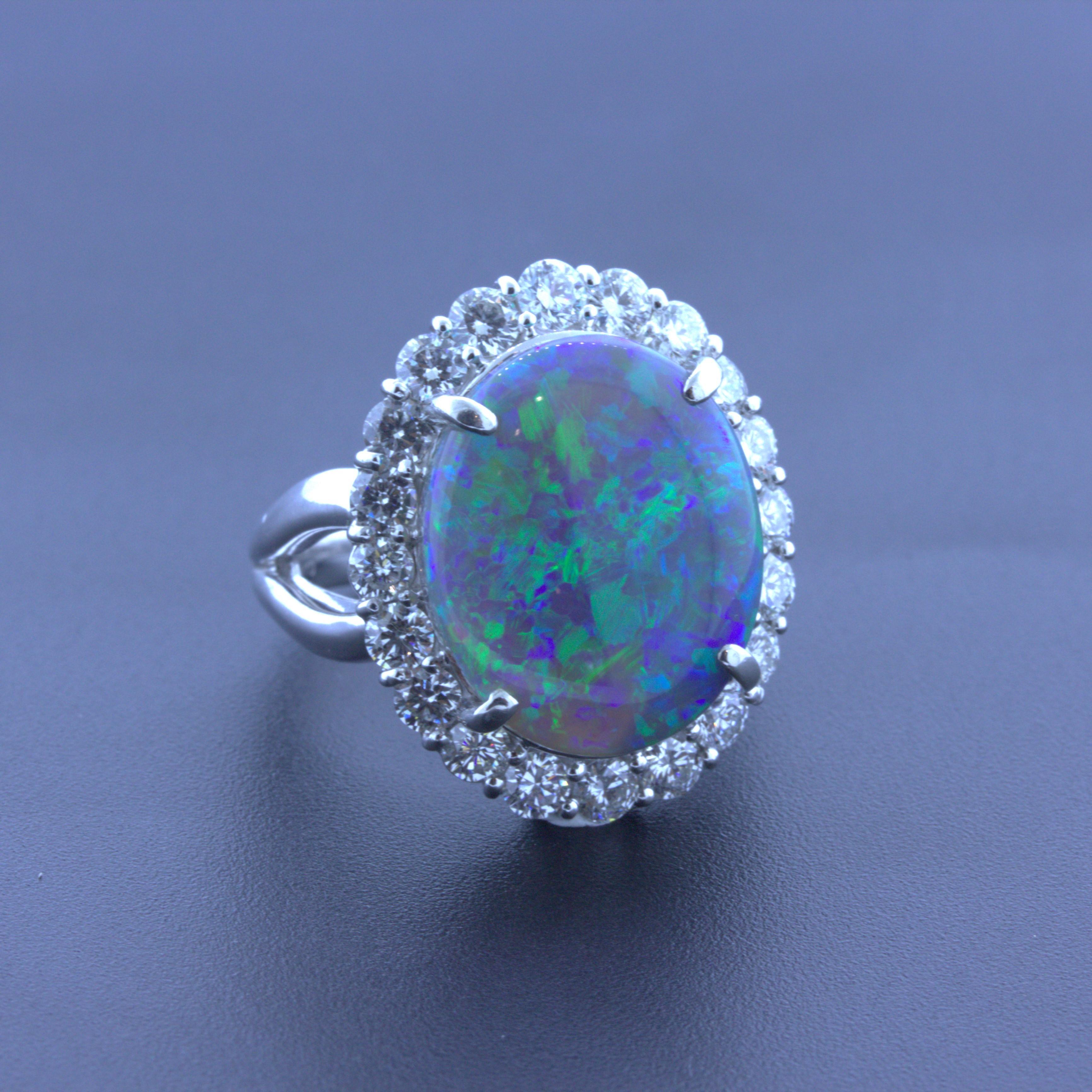 A very special and important opal takes center stage of this platinum ring. It weighs an impressive 10.18 carats and has excellent play-of-color as bright vibrant flashes of blue, green, violet, and red dance across the stone. The colors flash over