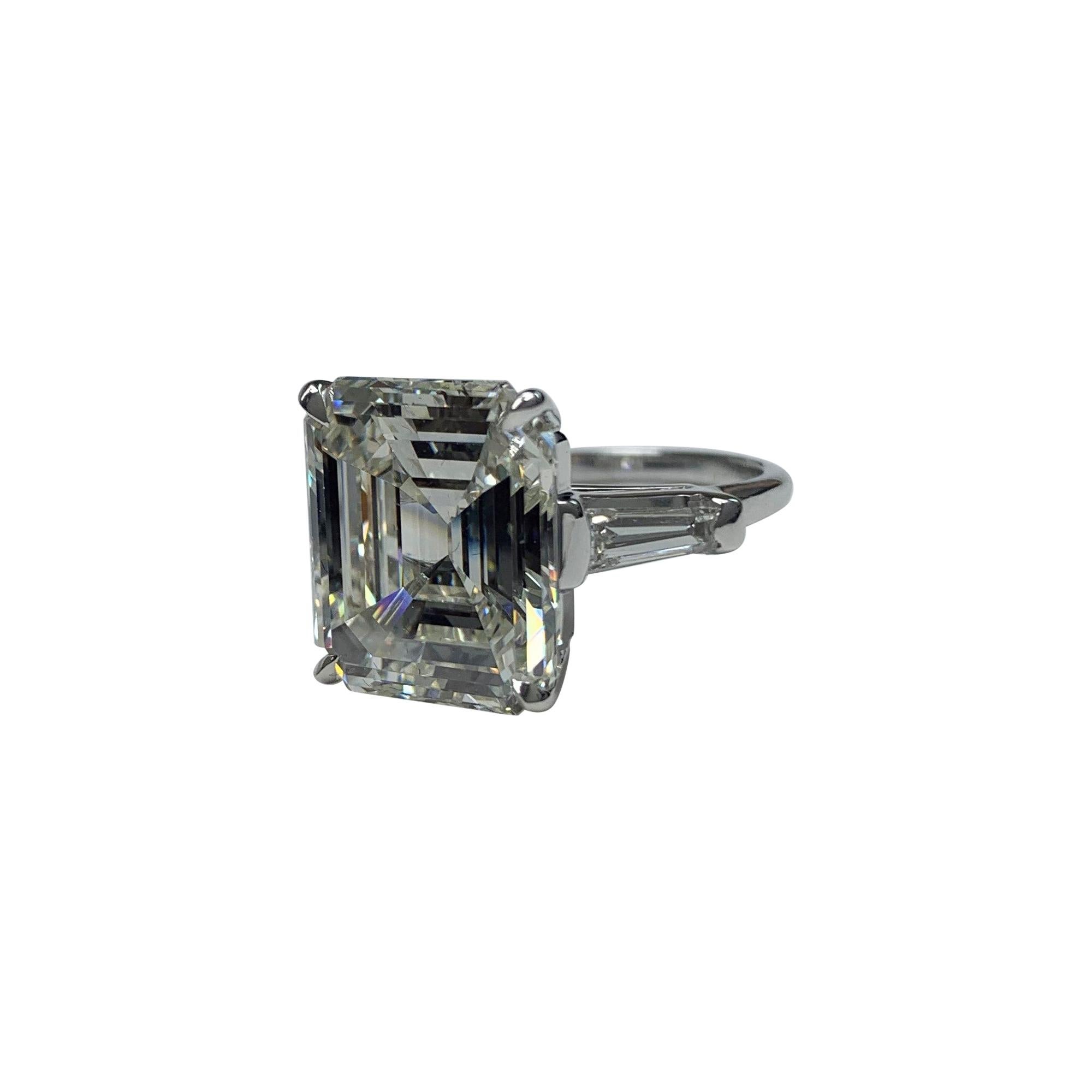 10.18 Carat Emerald Cut Diamond GIA Certified ad J in Color and VS1 in Clarity. GIA Certificate Number 5201414977.
The emerald Cut Diamond is set in the Center of Three Stone Ring with Two Tapered Baguettes on the sides. The Baguettes are aprox.