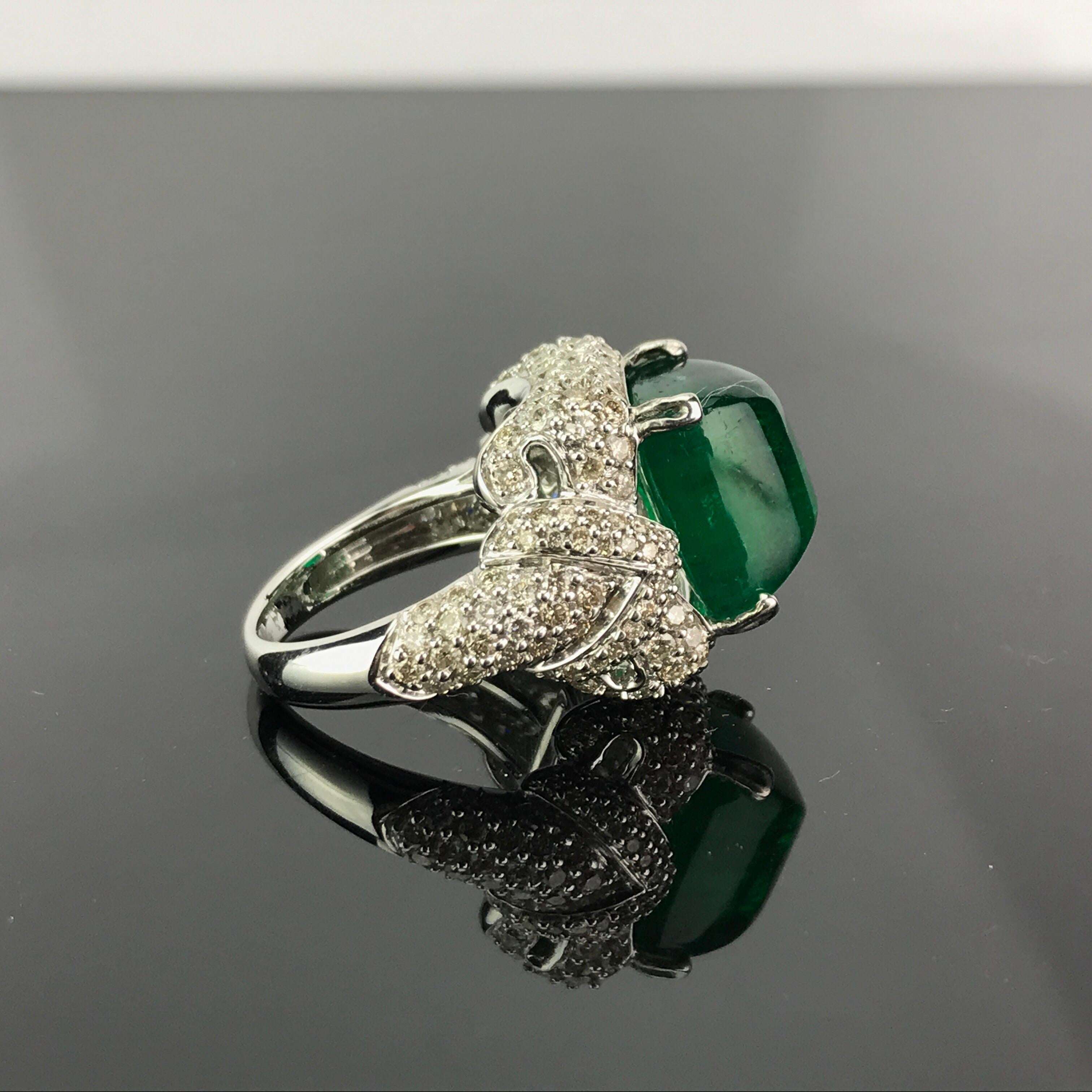 A truly unique cocktail ring, with 10.18 carat transparent, and great quality Emerald Sugarloaf centre stone sorrounded by Diamonds. Currently a ring size US 6, but we can resize the ring for you without additional cost. Certificate can be provided