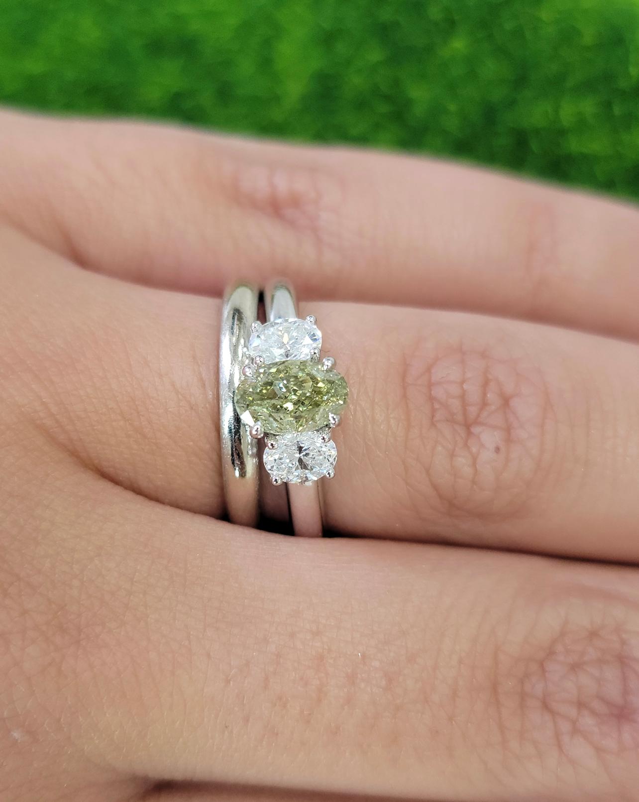 Natural color changing diamond certified as a Fancy Greenish Yellow but facing up predominantly Green. When the stone is left in the dark or heated the door temporarily changes to yellow
Set in 18kt White Gold with 0.59ct total weight of white