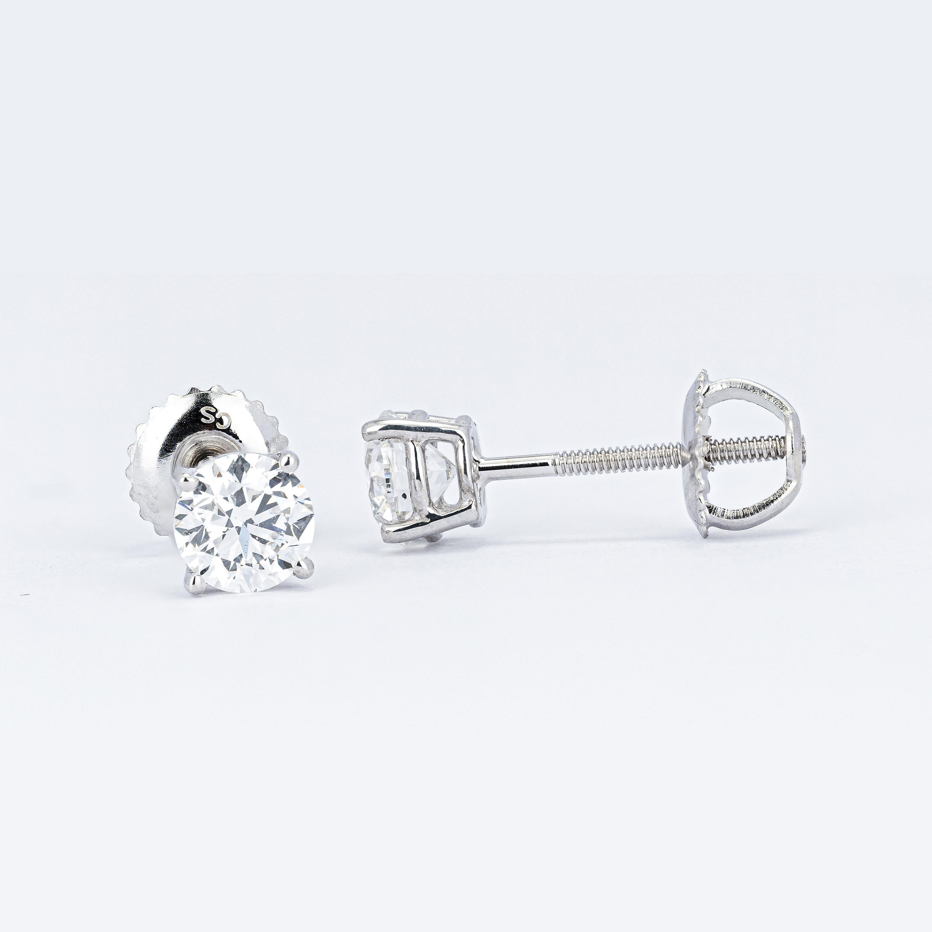 Simple and beautiful, these brilliant round-cut diamond studs shine brightly from every angle. The diamonds are set in four-prong baskets of 14kt white gold and ensure a stable and comfortable fit.

1.01ct
Weight: 1.2 grams
Length: 0.56 inches
Gold: