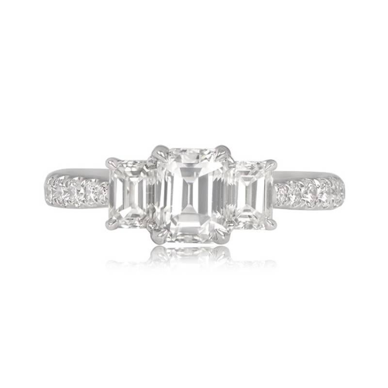 A captivating 18k white gold three-stone ring featuring a 1.01-carat emerald-cut center diamond, flanked by two smaller emerald-cut diamonds totaling 0.63 carats. All three diamonds are approximately J color and boast VS2 clarity. The ring's