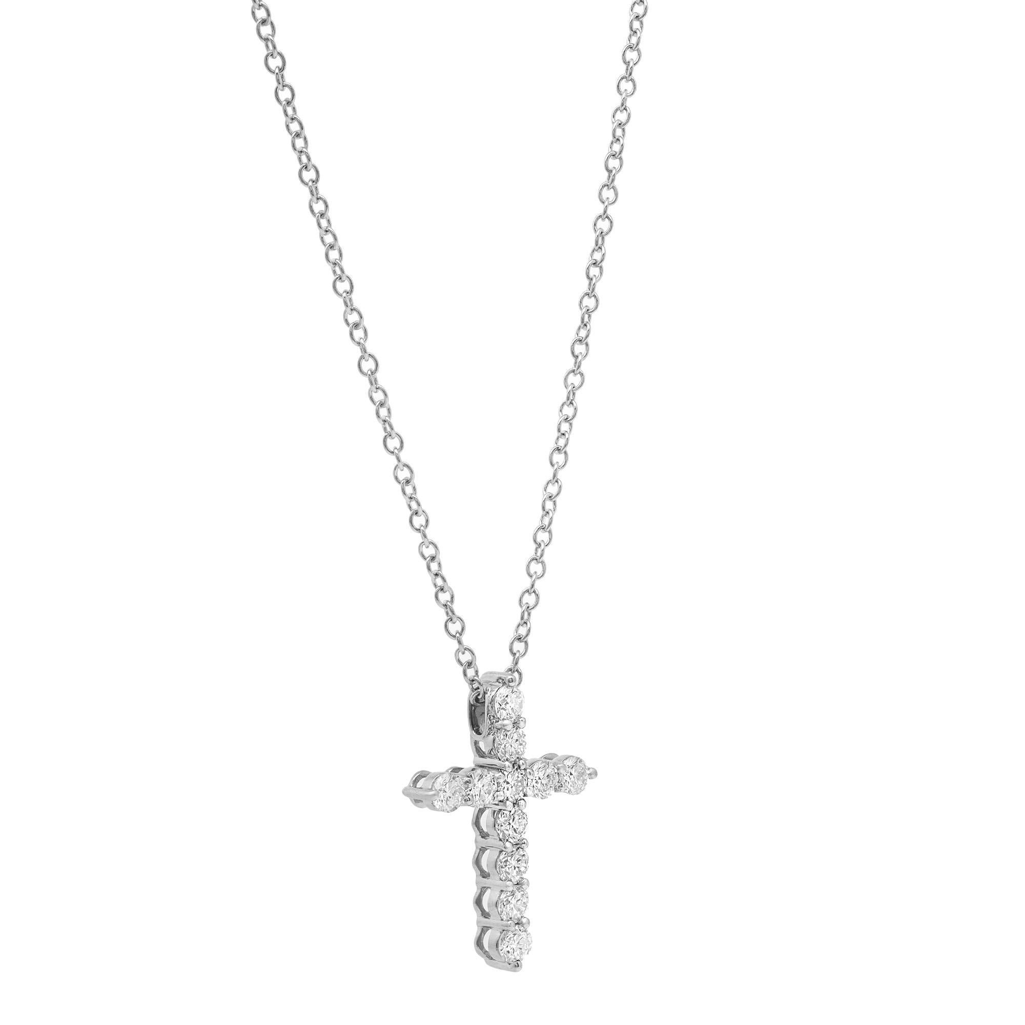 This gorgeous 18K white gold diamond cross pendant features 11 prong set round brilliant cut sparkling diamonds weighing approximately 1.01 carats in total. Diamond quality: G-H color and VS-SI clarity. Pendant size: 21.9mm x 16.2mm. Chain length: