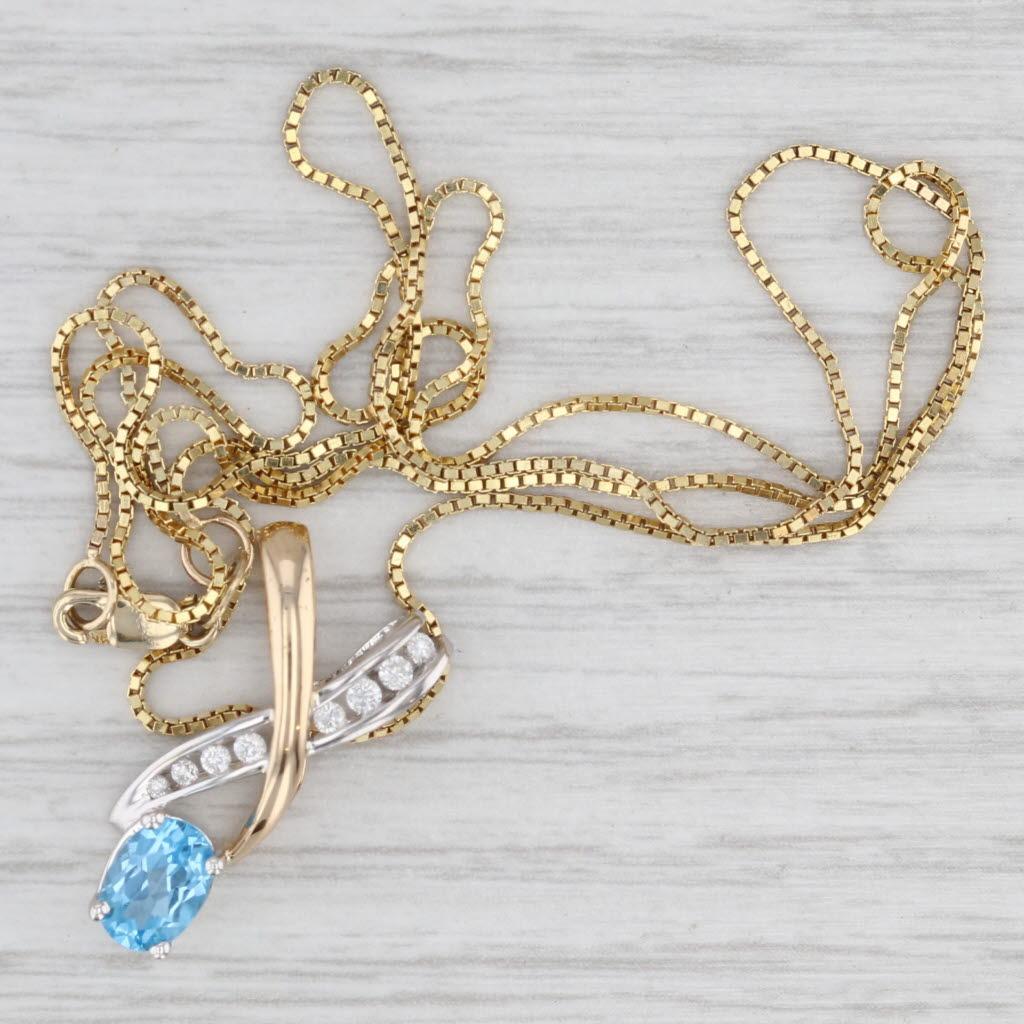 Gemstone Information:
- Natural Diamonds -
Carats - 0.12ctw
Cut - Round Brilliant 
Clarity - I1 - I2
Color - G - H

- Natural Topaz -
Carats - 0.89ct
Cut - Oval Brilliant
Color - Light Blue
Treatment - Routinely Enhanced

Metal: 14k Yellow & White