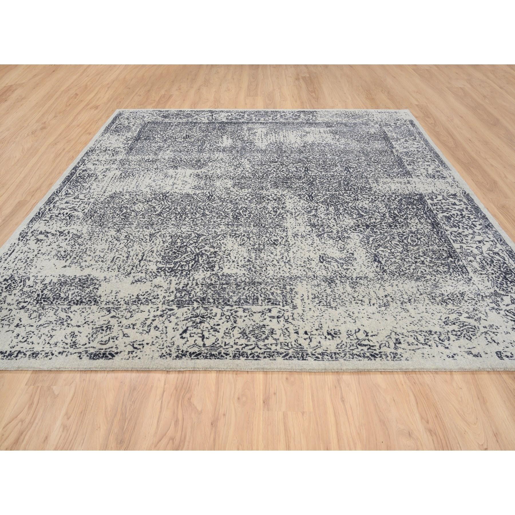 This is a truly genuine one-of-a-kind Fine Jacquard with Erased Design Wool and Plant Based Silk Hand Loomed Light Gray Oriental Square Rug. It has been Loomed for months and months in the centuries-old weaving craftsmanship techniques by expert