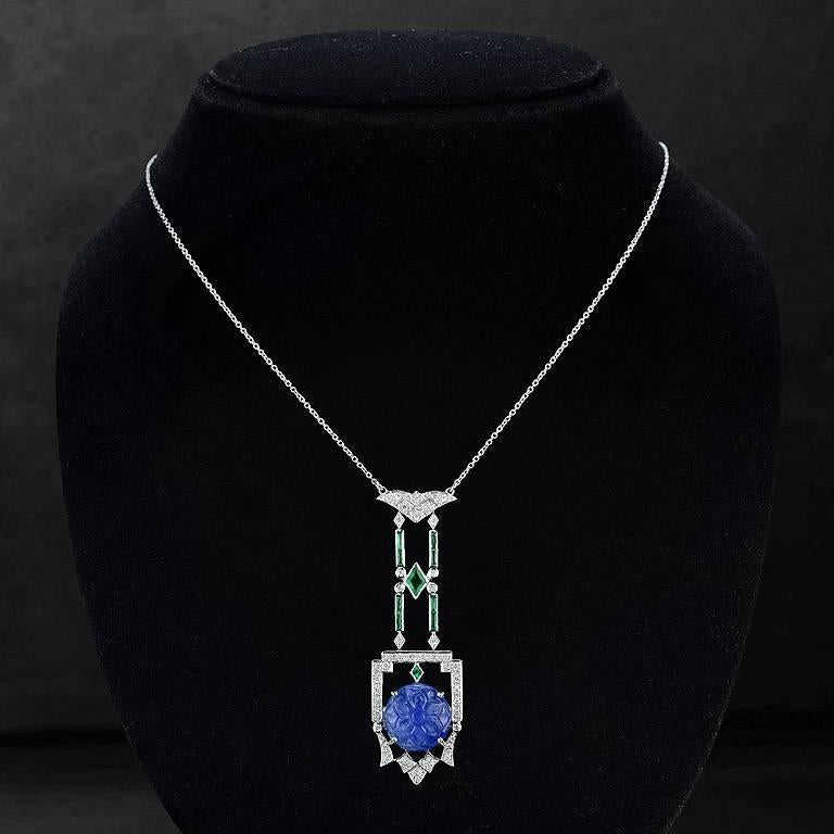Carved Blue Sapphire from Myanmar 10.20 Carat in the center set on 18K White Gold Pendant.  Emerald in Diamond Shape 1 Piece 0.52 Carat French Cut Emerald 9 Pieces 1.25 Carat and Brilliant Cut Diamond 53 Pieces 0.50 Carat

The length of this