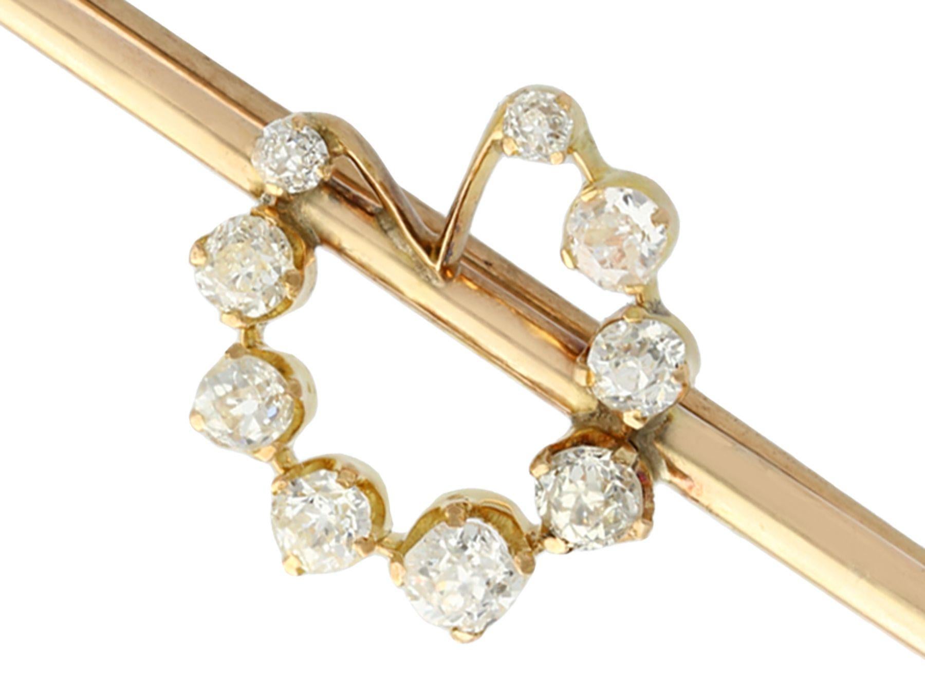 An exceptional antique 1.02 carat diamond and 12k yellow gold and silver set pin brooch; part of our diverse antique estate jewelry collections.

This exceptional, fine and impressive antique pin brooch has been crafted in 12k yellow gold and
