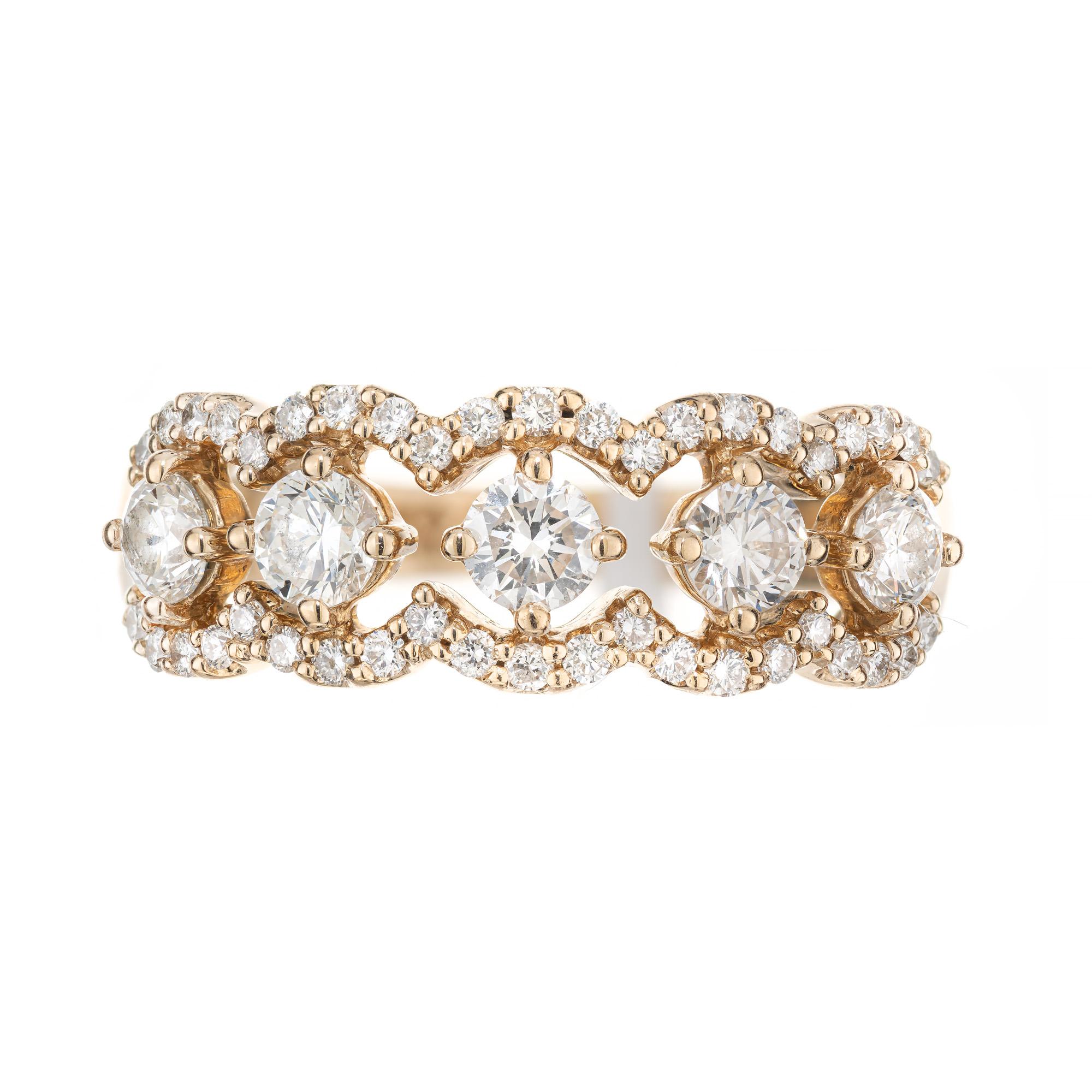 Beautiful and unique diamond wedding band ring. Five round brilliant cut diamond totaling .70cts. in a suspended style setting each having a halo of scrolling round cut diamonds totaling .32cts. 14k yellow gold setting. This ring can worn as a