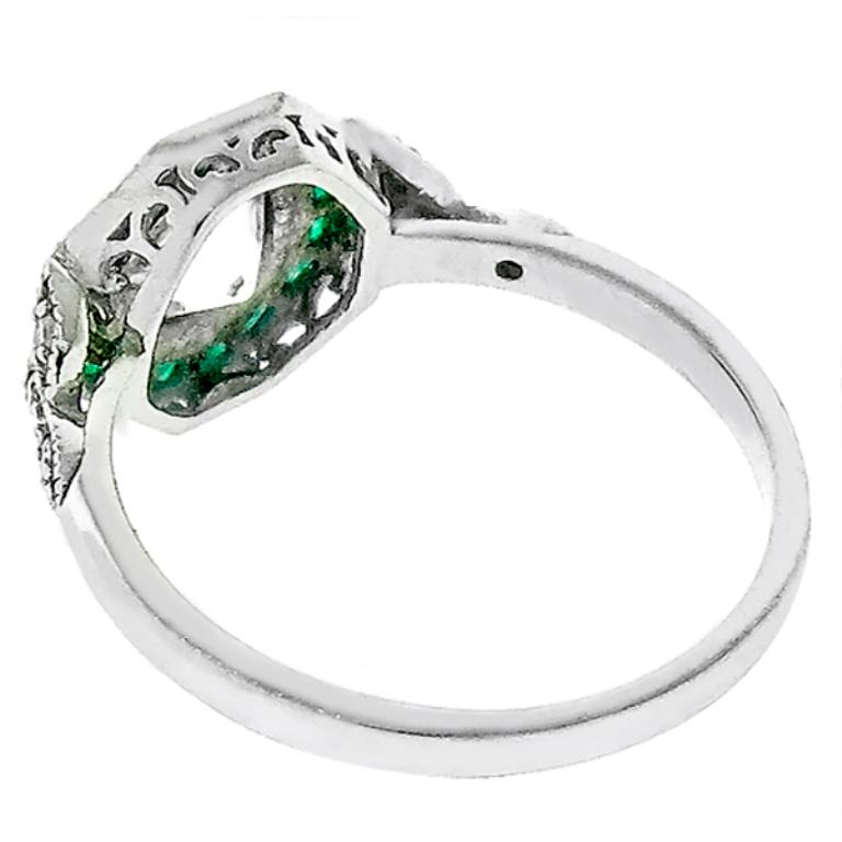 This stunning platinum engagement ring is centered with a sparkling GIA certified old European cut diamond that weighs 1.02ct. graded K color with VVS2 clarity. The center diamond is accentuated by lovely faceted cut emerald and round cut diamond