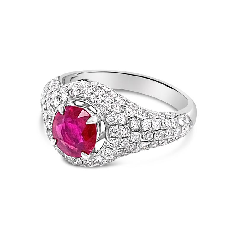 This gorgeous ring features a 1.02 carat oval cut natural Burma ruby, no heat, set in 18 karat white gold surrounded by 1.32 carat total weight in pave set diamonds that go about halfway down the band. This ring is currently a size 6 but can be