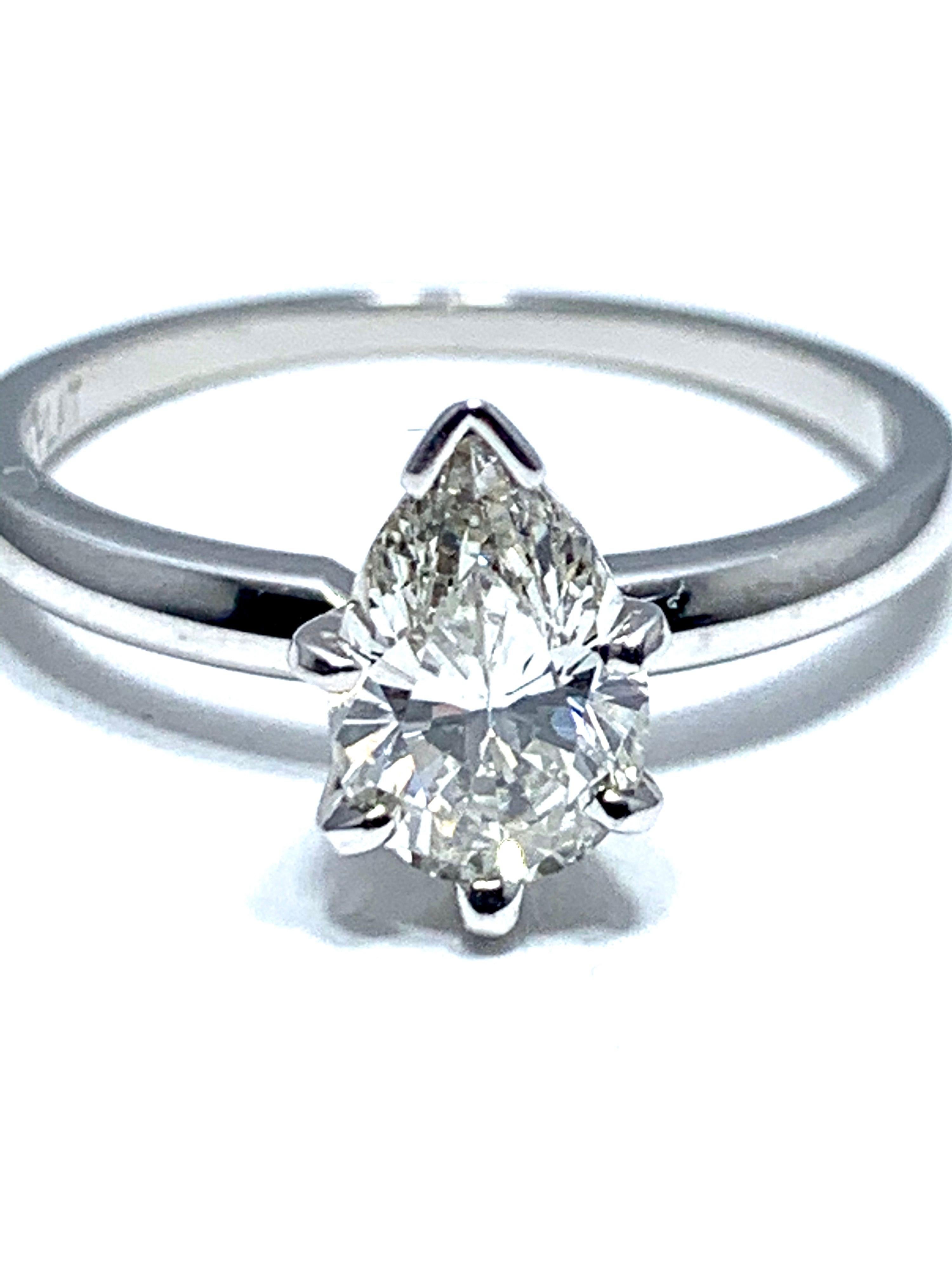 An eye catching 1.02 carat pear shape brilliant cut diamond engagement ring.  The center diamond is set in a six prong platinum head on a polished platinum shank.    The center diamond is graded by GIA as J color, VVS2 clarity, and displays a fury