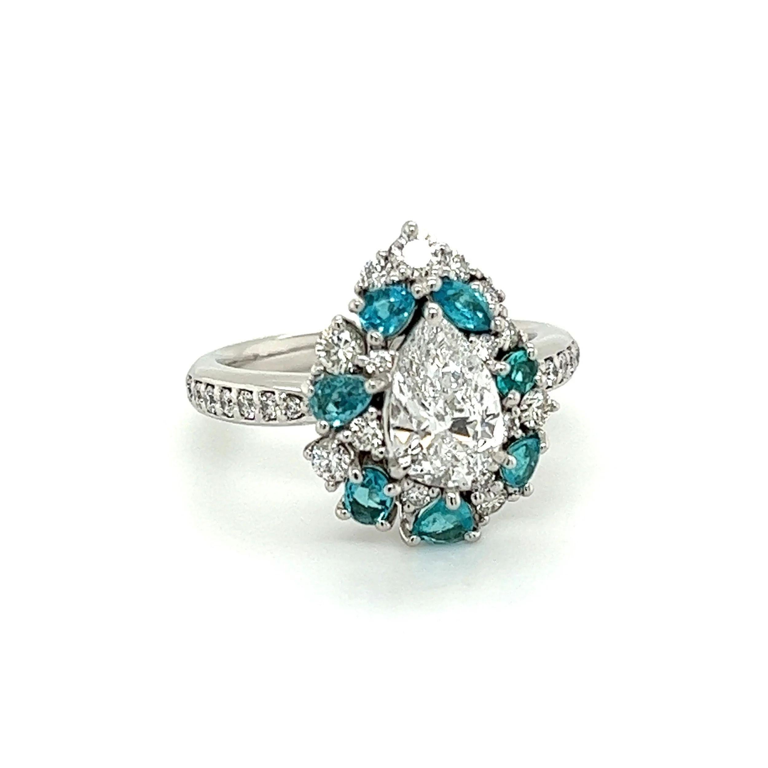 Simply Beautiful! Diamond and Paraiba Platinum Cluster Ring. Centering a securely nestled Hand set 1.02 Carat Pear shape Brilliant Diamond D-SI1 GIA. Beautifully surrounded by Paraiba weighing approx. 0.52tcw and Diamonds, approx. 0.54tcw. Hand