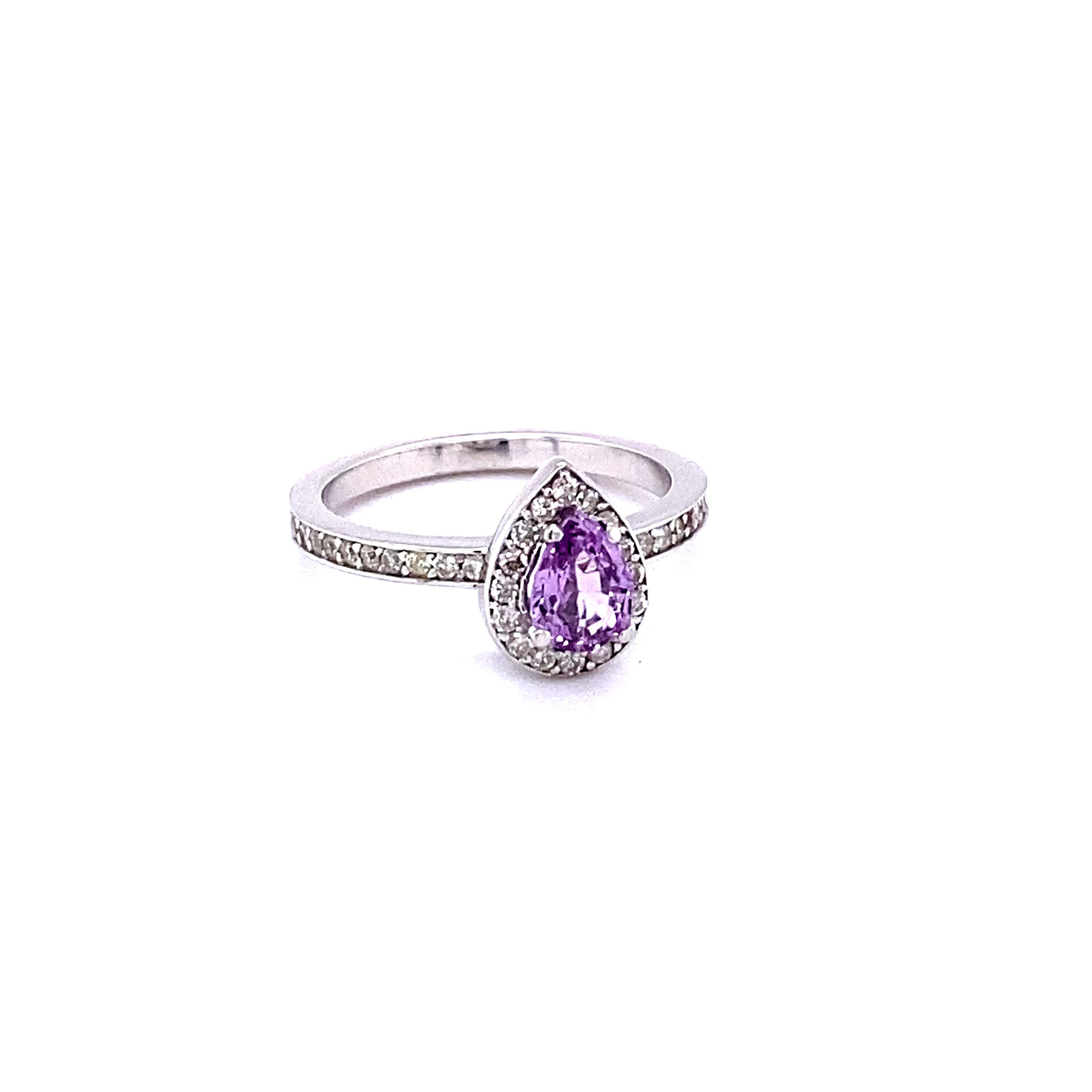 This beautiful ring has a 0.82 Carat Pear Cut Pink Sapphire and is surrounded by 37 Round Cut Diamonds that weigh 0.20 Carats. The total carat weight of the ring is 1.02 Carats. 

The ring is beautifully set in 14K White Gold with an approximate