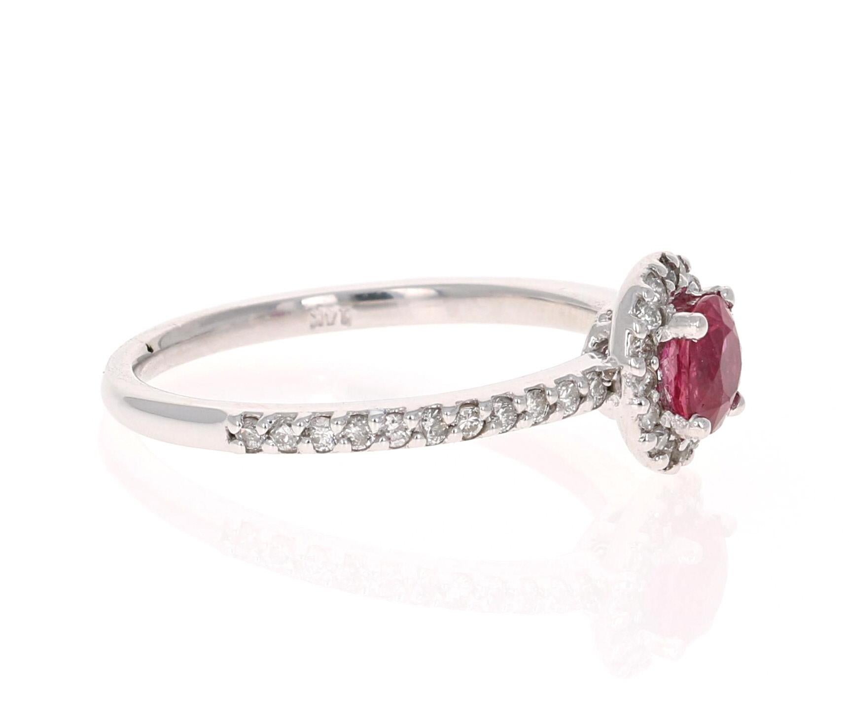 This elegant and dainty Ruby Diamond Ring can be a modern Engagement/Promise ring. It has a natural Burmese Ruby that is 0.65 Carats with a Halo of 38 Round Cut Diamonds weighing 0.37 Carats. 
It is set delicately in 14K White Gold and is a ring