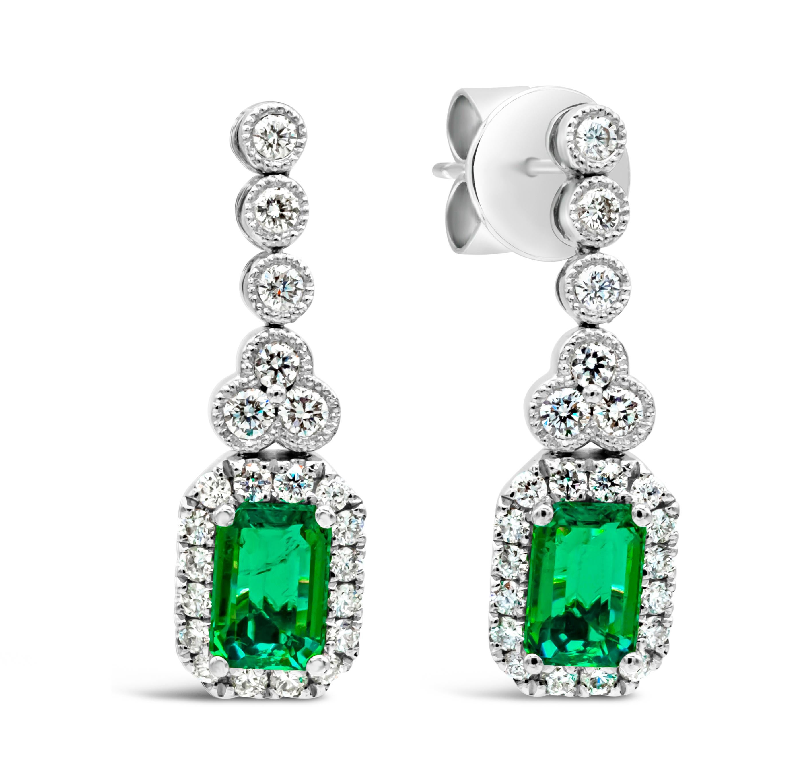 Contemporary 1.02 Carats Total Emerald Cut Green Emerald & Round Diamond Halo Dangle Earrings For Sale