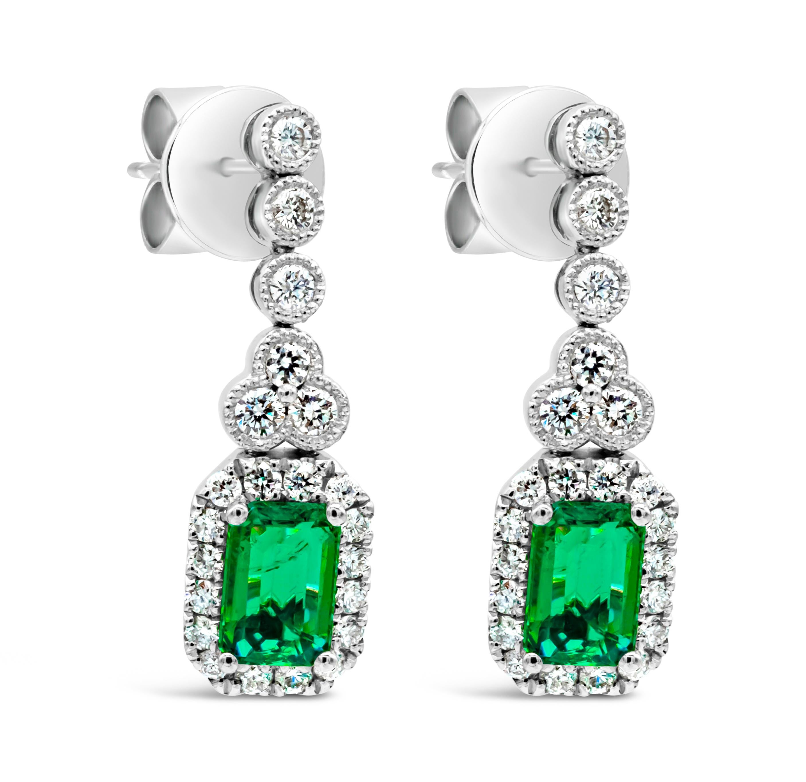 1.02 Carats Total Emerald Cut Green Emerald & Round Diamond Halo Dangle Earrings In New Condition For Sale In New York, NY