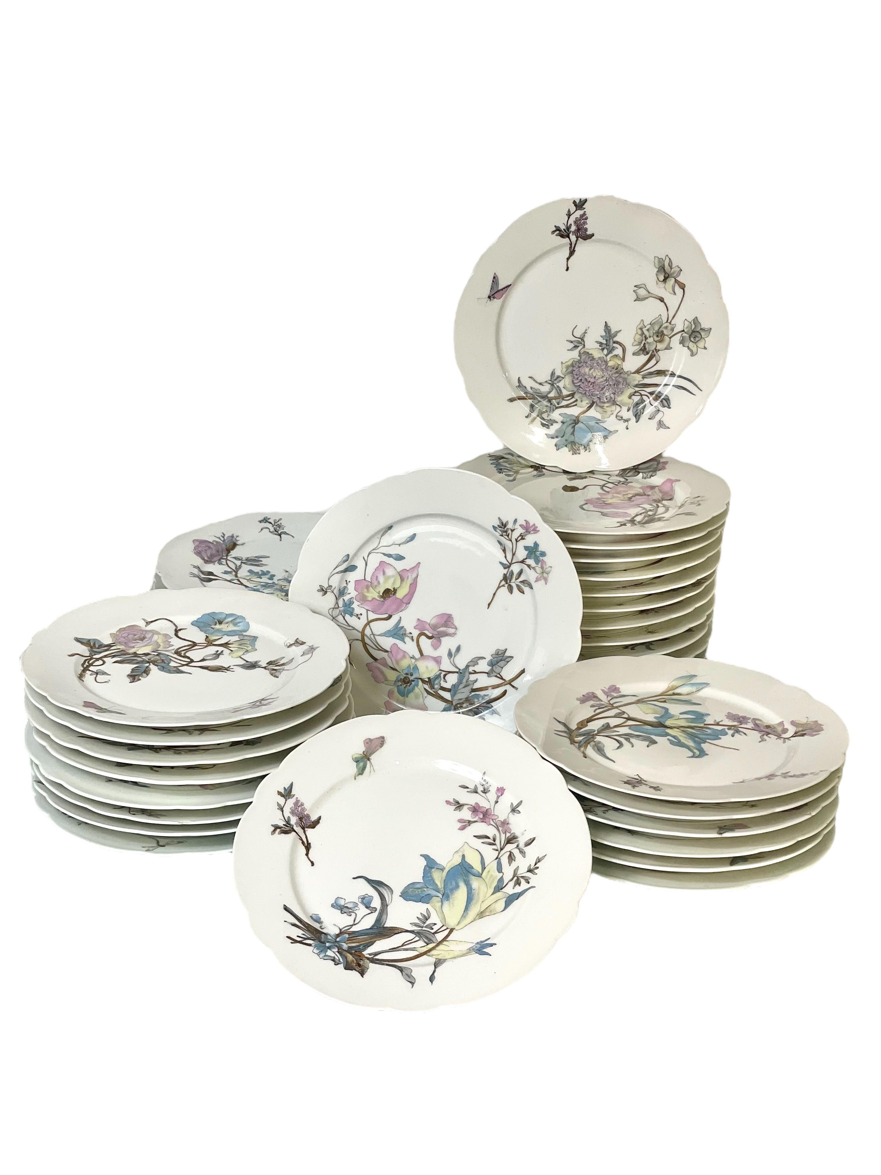 An extensive and exquisitely beautiful table service in white porcelain, possibly Limoges, dating from the 19th century. Each item in the set is hand-painted with wonderfully detailed butterflies and sprays of wild flowers, while the rim of almost