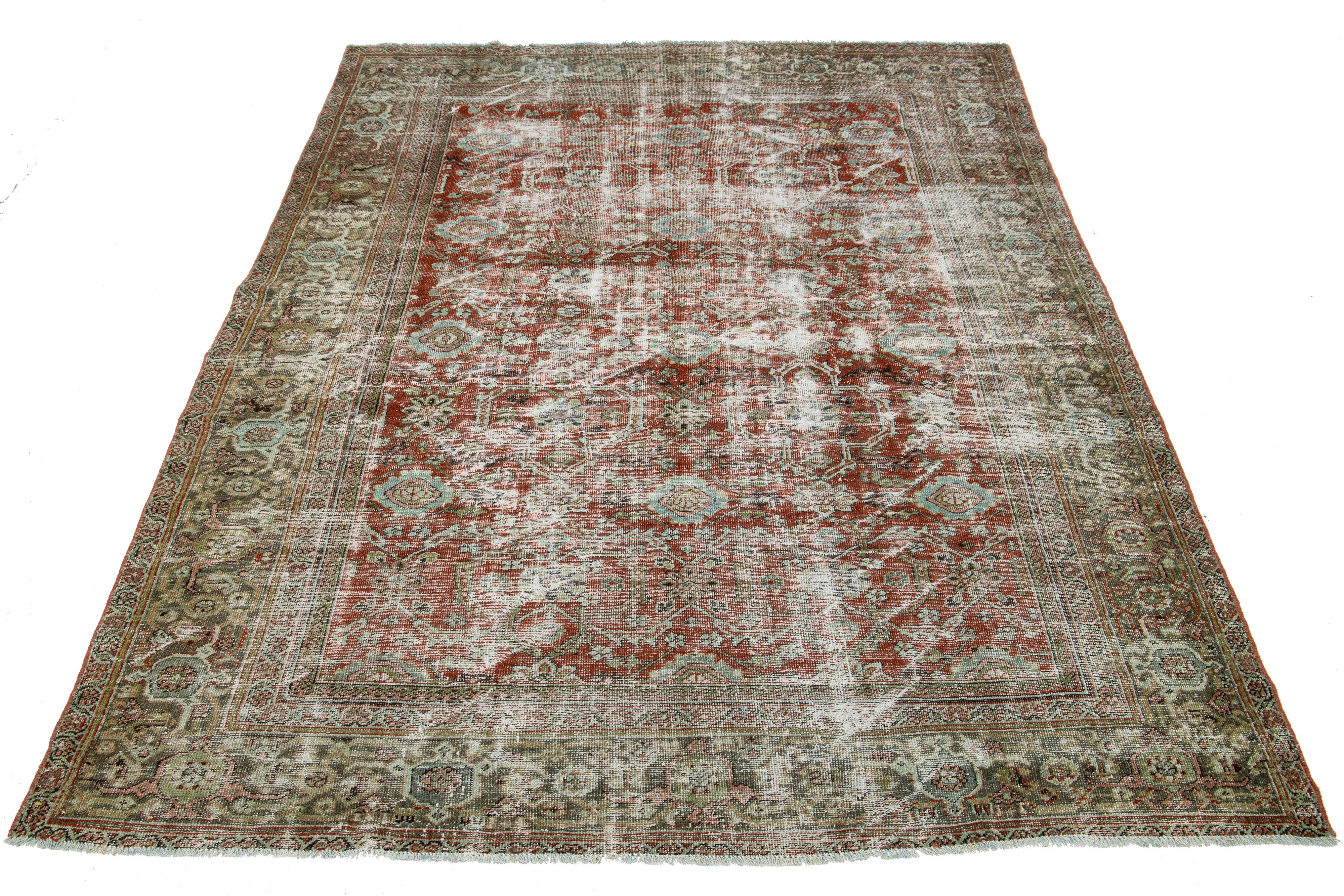 Antique Mahal wool rug with rust field. Floral motif in blue, pink, and green hues.

This rug measures 6'9