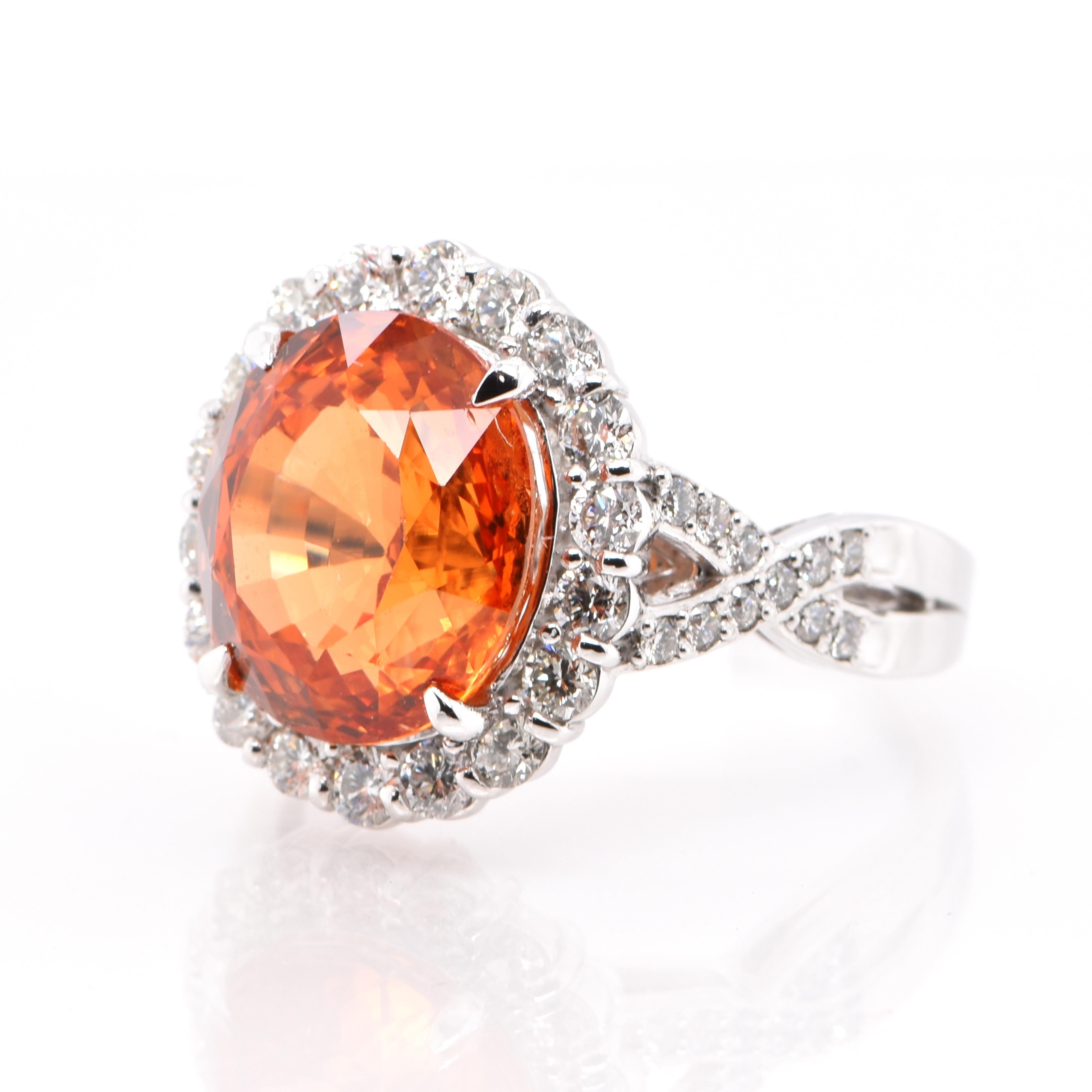 An absolutely gorgeous Cocktail Ring featuring a 10.21 Carat, Natural Spessartine (Mandarin) Garnet and 1.01 Carats of Diamond Accents set in Platinum. Garnets have been adorned by humans throughout history from Ancient Egypt, Rome and Greece. They