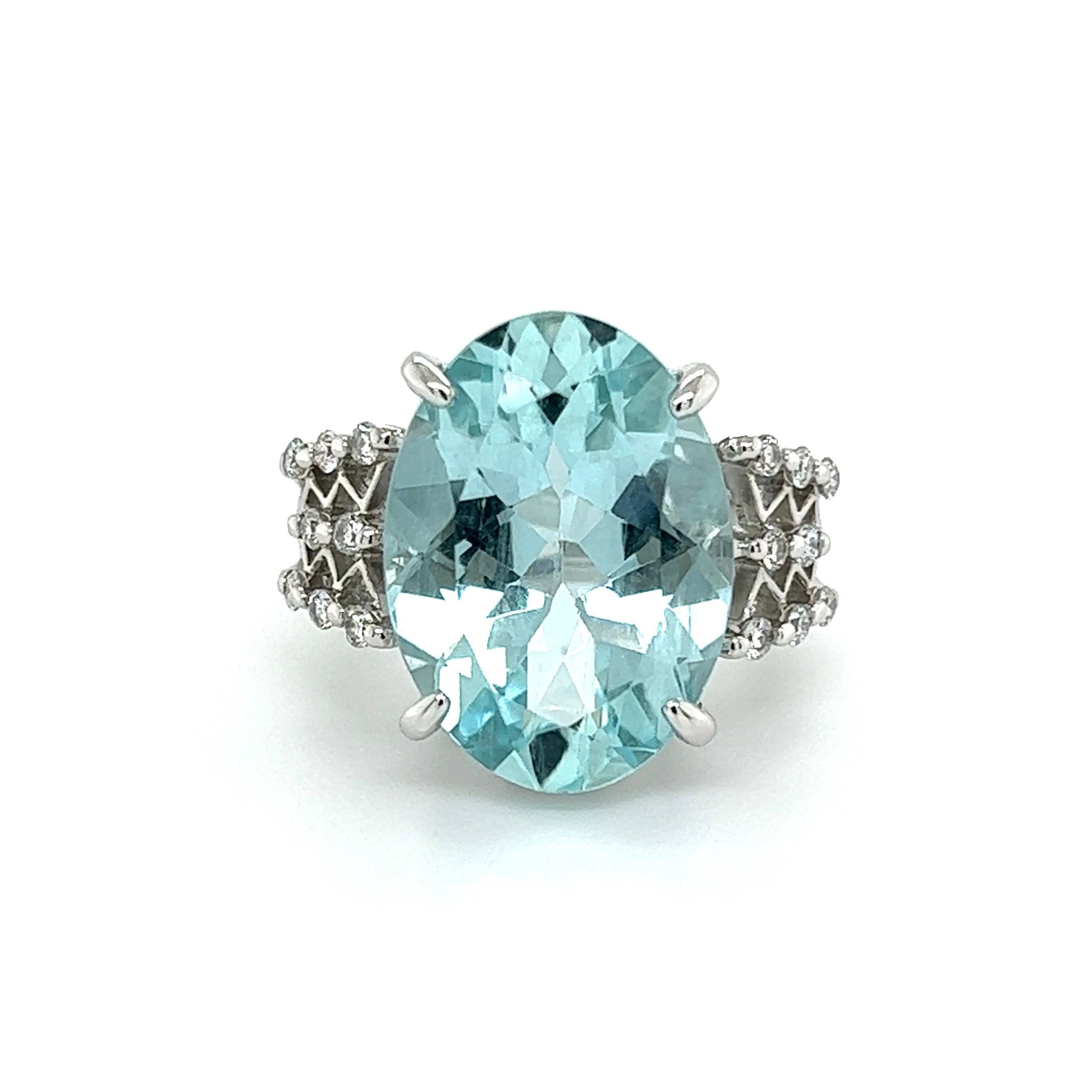 Simply Beautiful! Finely detailed Aquamarine and Diamond Platinum Cocktail Ring. Centering a securely nestled Oval Aquamarine, weighing approx. 10.21 Carats either side set with Diamonds, approx. 0.32tcw. Approx. dimensions: 1.06” l x 0.87” w x