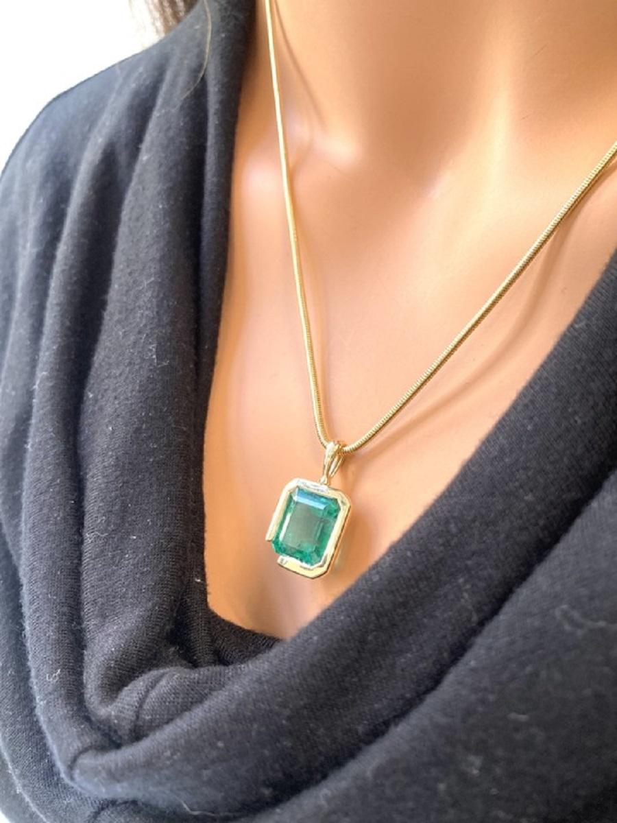 The pendant is set in 18k yellow gold, and the emerald itself has an octagonal/step cut with a substantial weight of 10.22 carats. Emeralds are known for their vibrant green color, and the octagonal/step cut is a classic and elegant choice that
