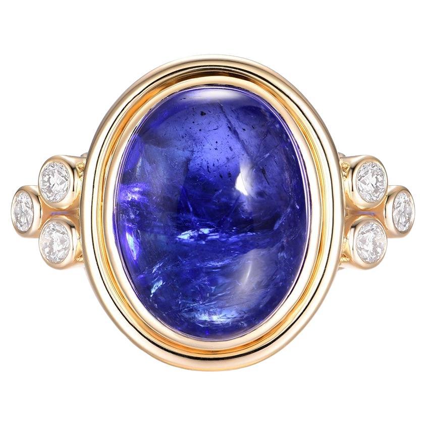 This stunning cocktail ring is a true statement piece, featuring a magnificent 10.22 carat cabochon tanzanite set in luxurious 14K yellow gold. The tanzanite's deep violet-blue hues are vivid and captivating, with the smooth, rounded cabochon cut
