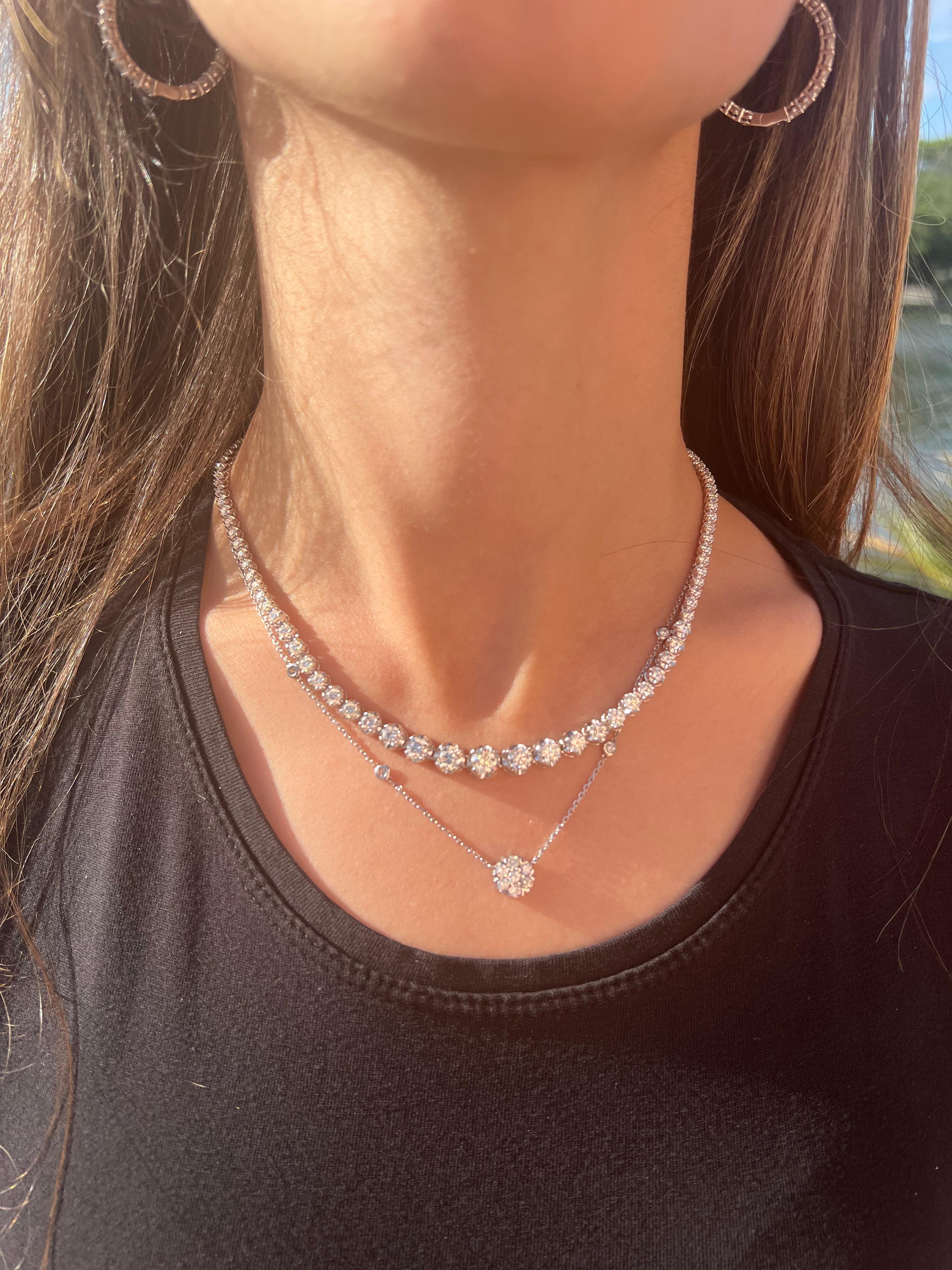 This unique 10.23ct Graduated Diamond Tennis Necklace is a Head turner. Each diamond is set in a crown prong setting giving off maximum brilliance and shine. the Center stone is the largest diamond ( .70ct) then it continues up the neck with smaller