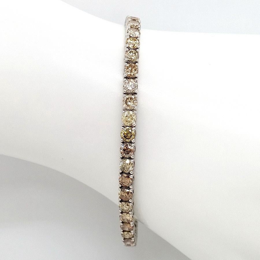 FOR U.S. BUYERS NO VAT

This gorgeous and breathtaking 14kt white gold tennis bracelet harmonically combines several colors of round brilliant diamonds totaling 10.24 carats which create a very unique and colorful design. This mesmerizing bracelet